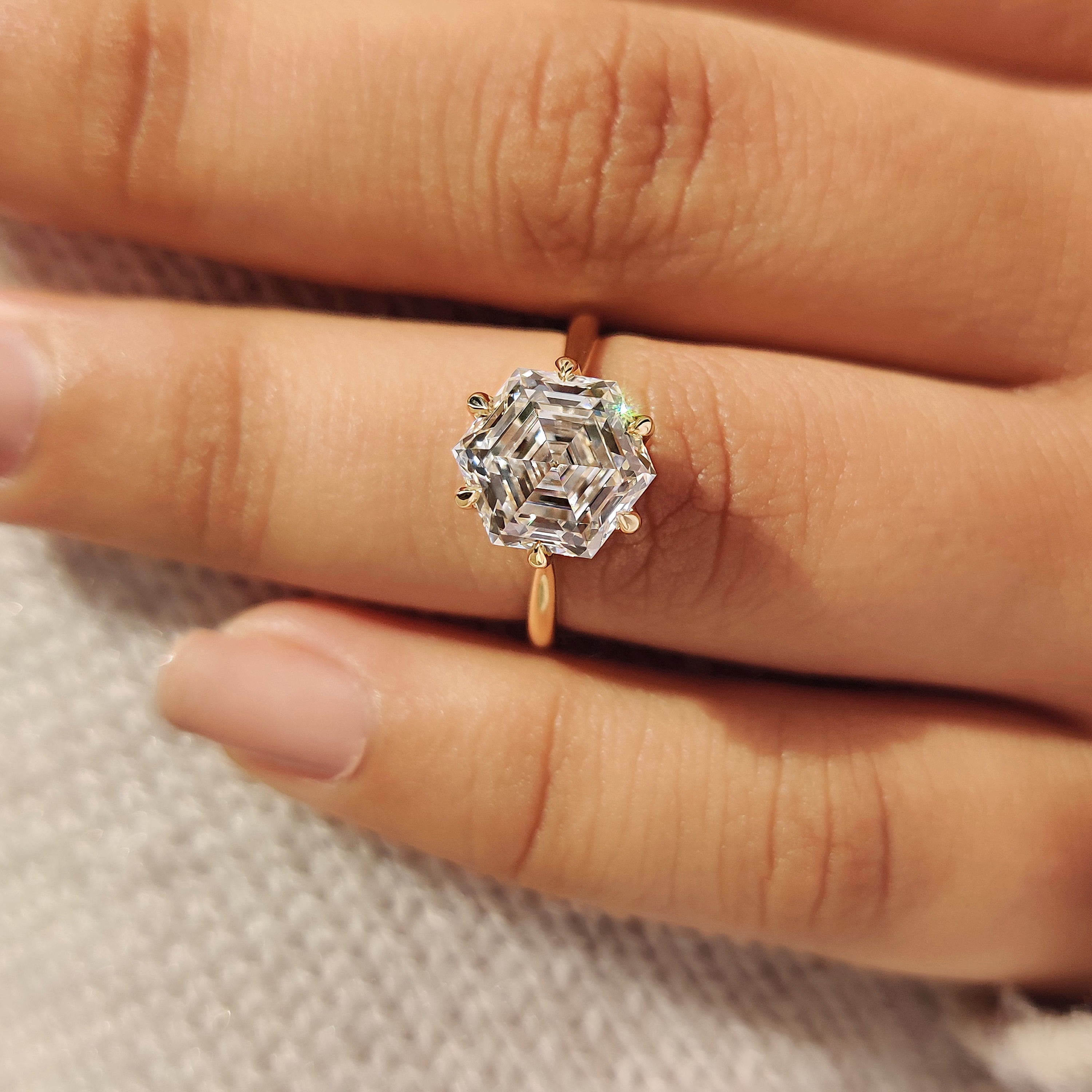 Solitaire hexagon diamond ring with tulip style setting details
