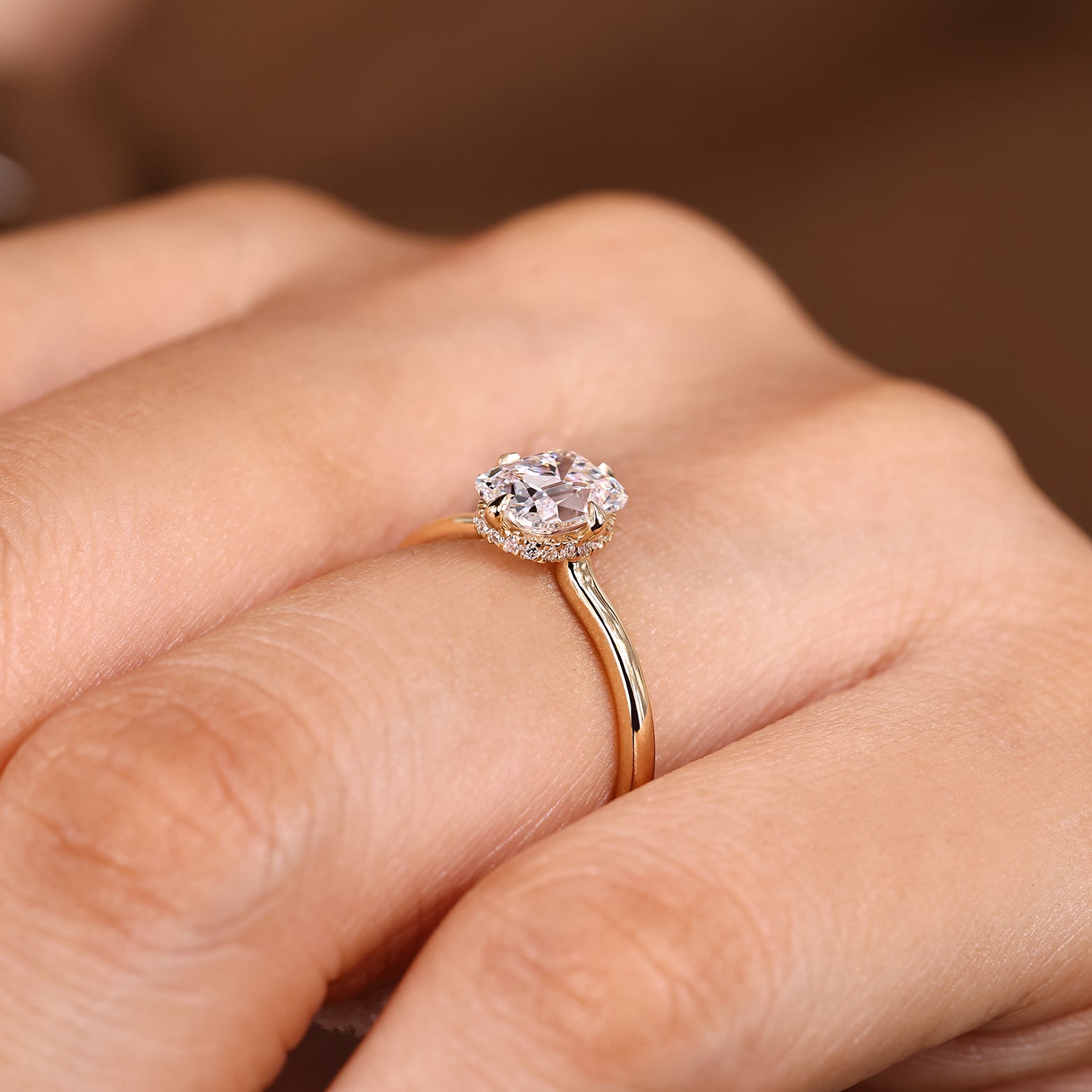 Cushion cut solitaire ring with hidden halo setting design

