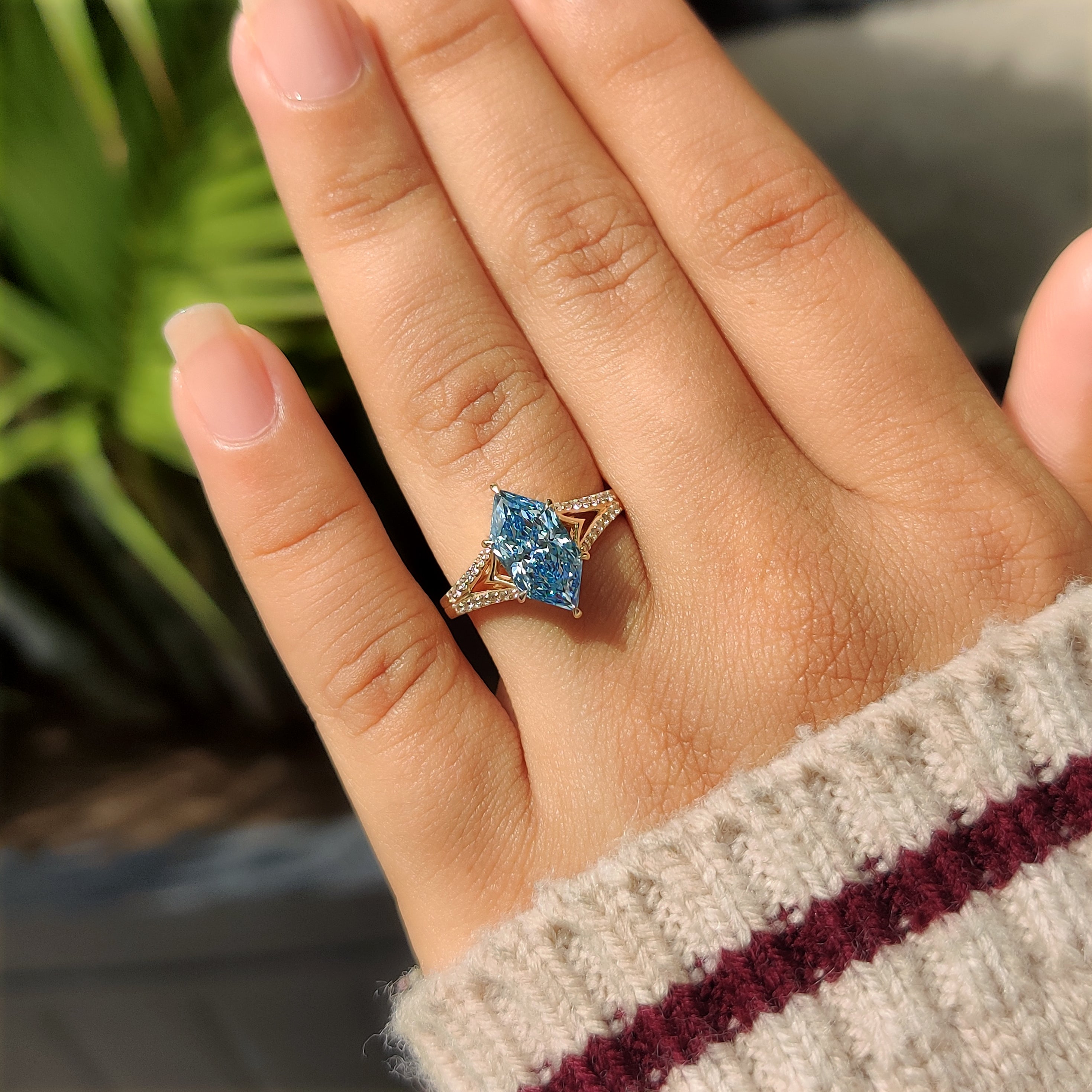 Split shank marquise diamond ring with round accents
