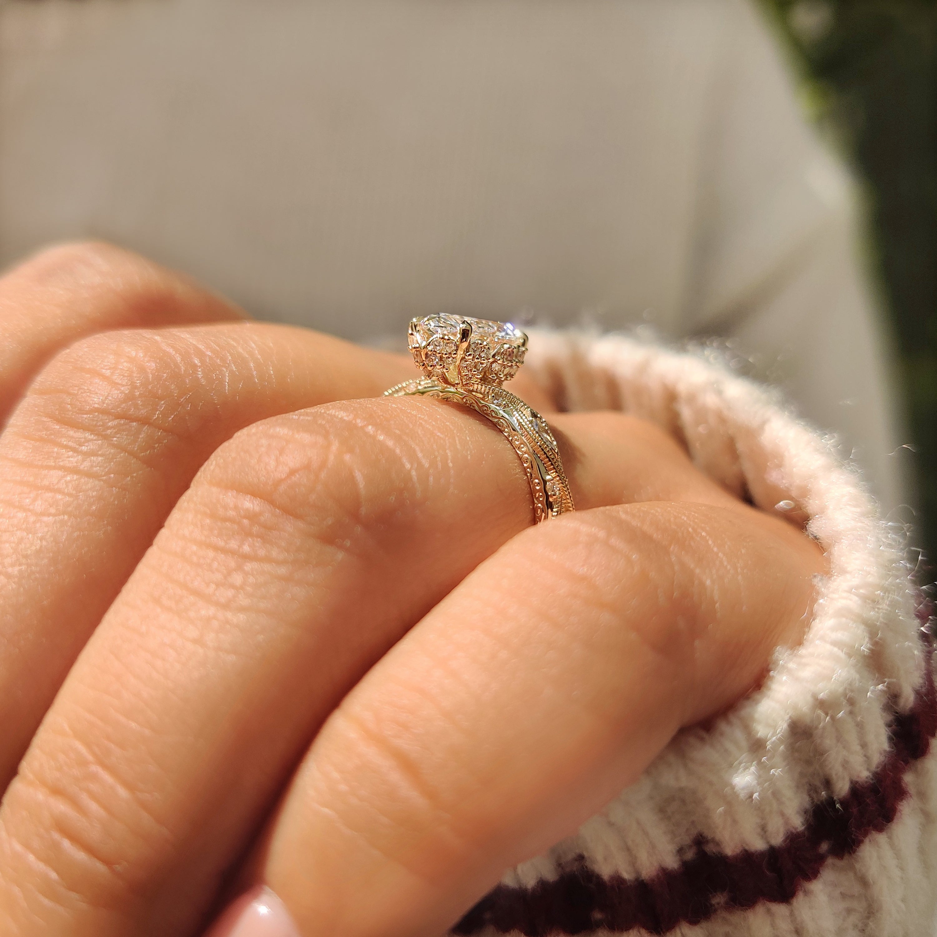 Marquise and round stones ring with milgrain edges.
