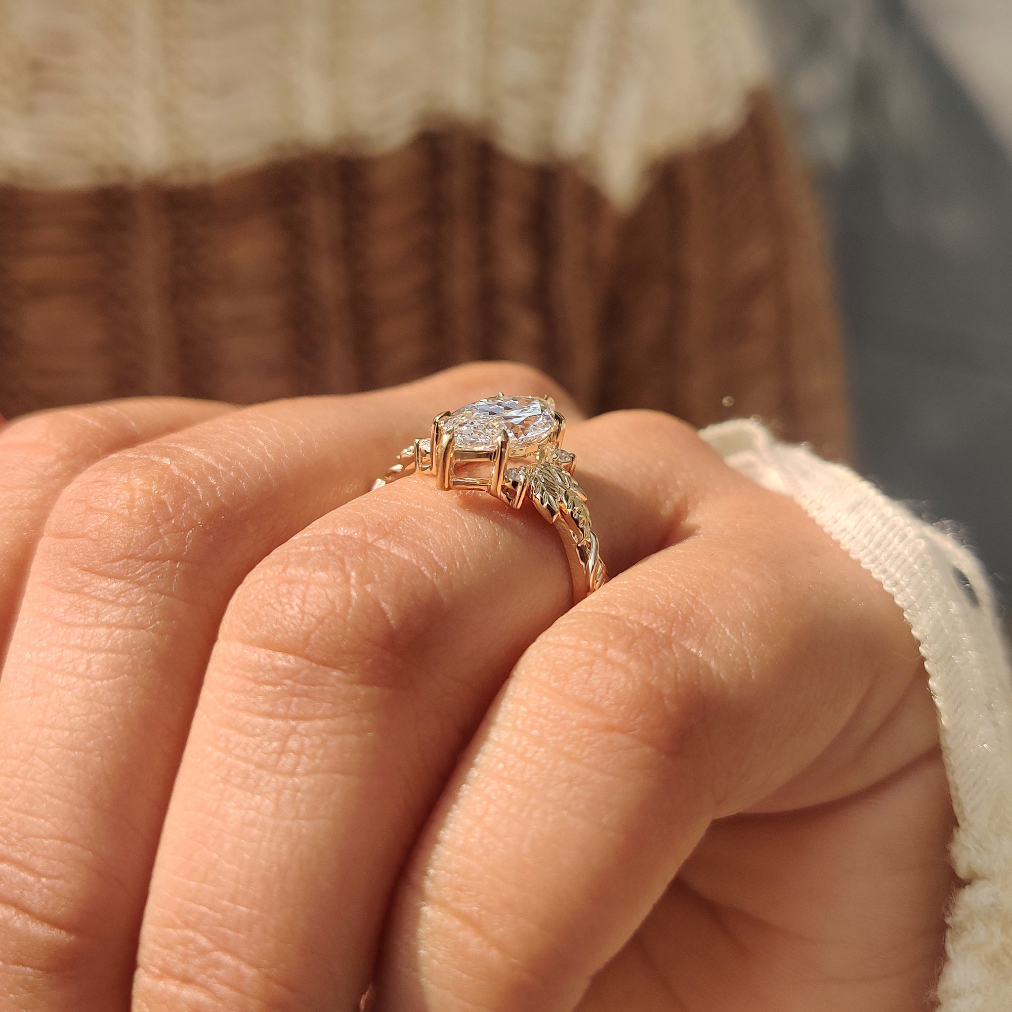 Nature style marquise diamond ring with round side diamonds.
