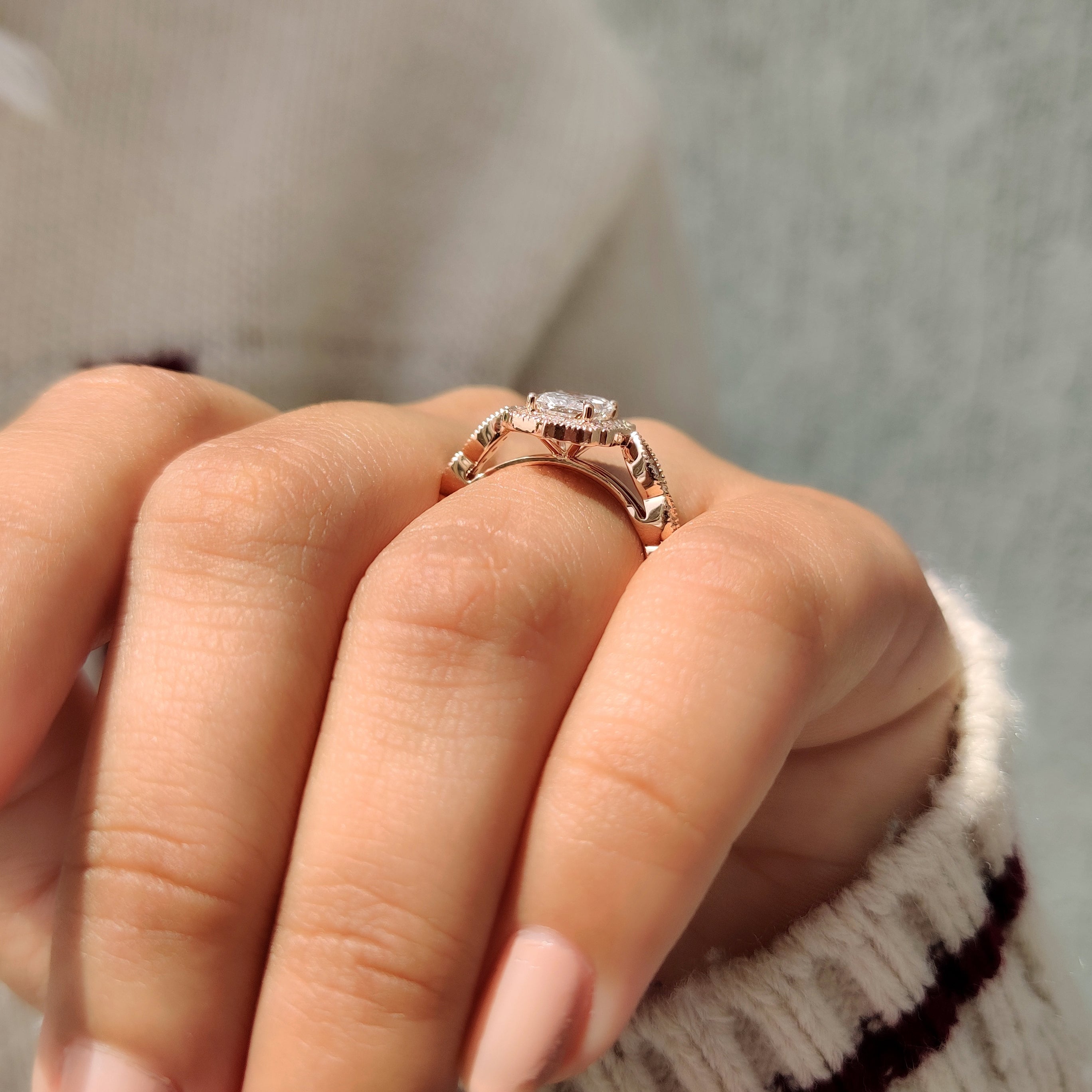 Radiant cut diamond ring with round pave details.
