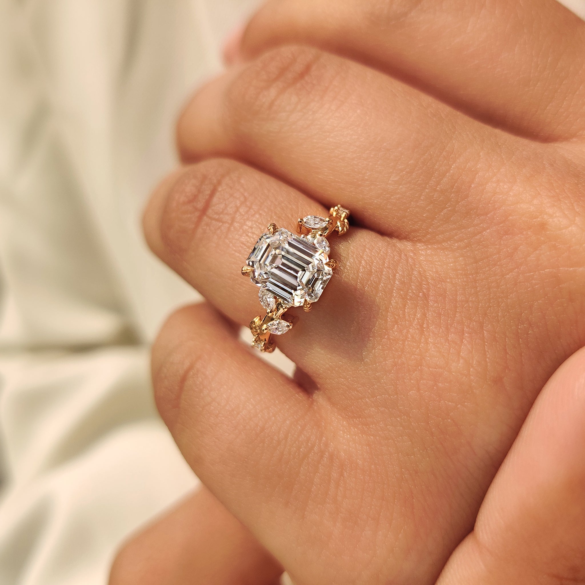 Old mine emerald cut diamond ring with marquise and round side stone
