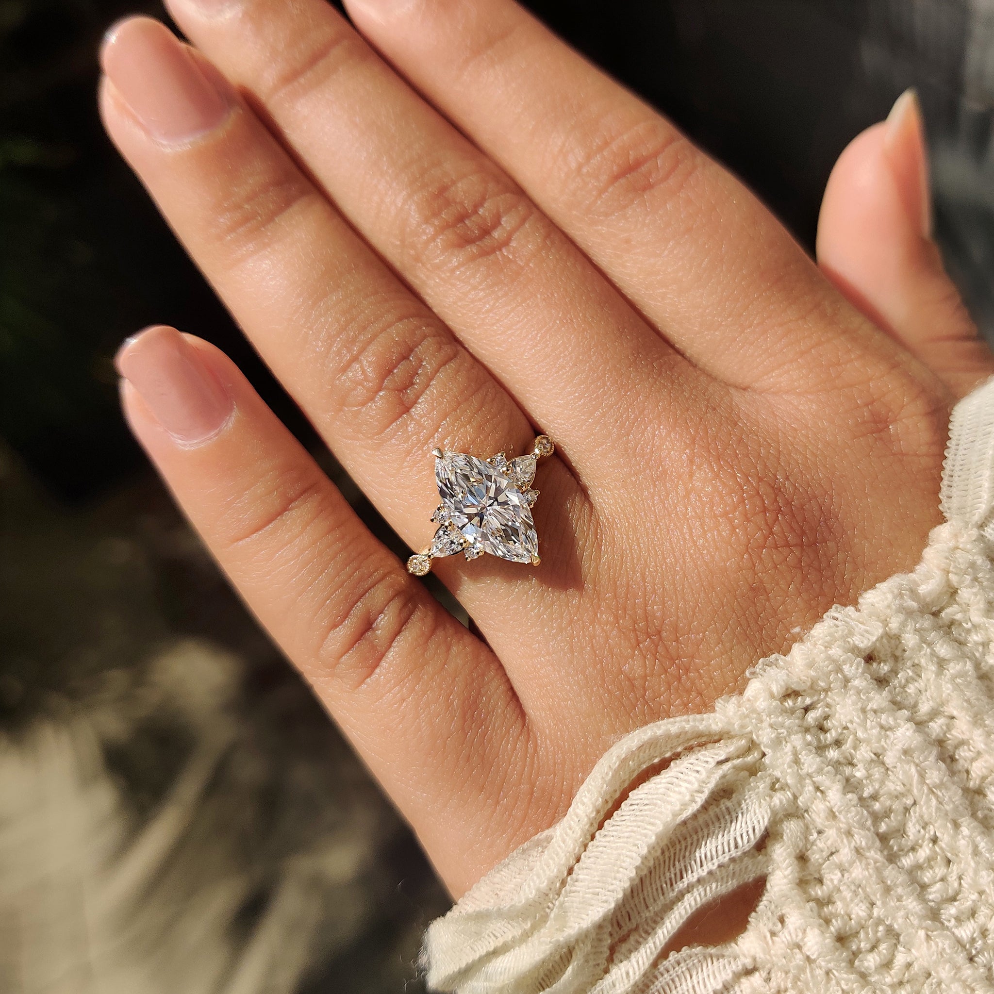 Marquise cut ring with milgrain outline and side stones.
