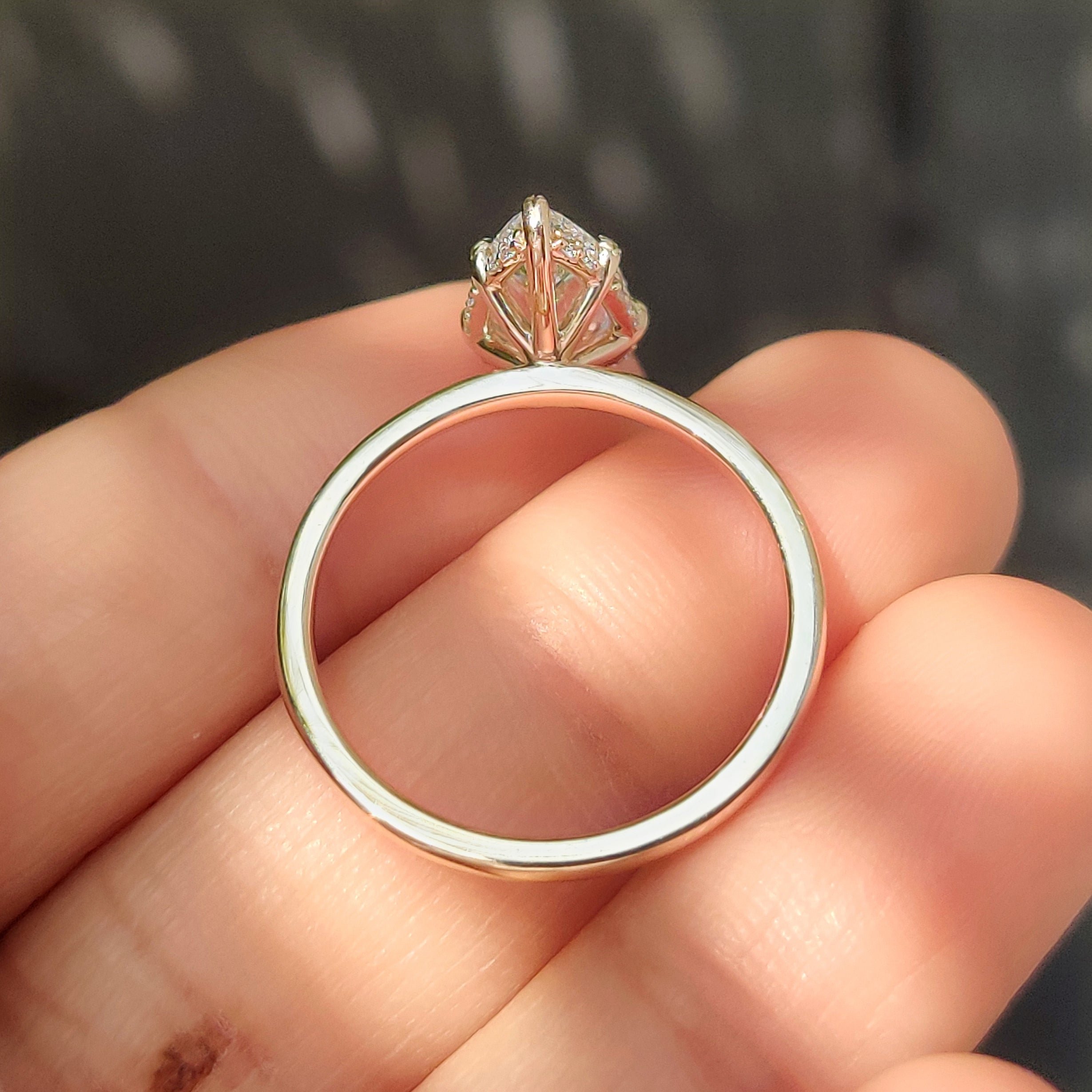 Pear diamond ring with delicate leaf prong details.
