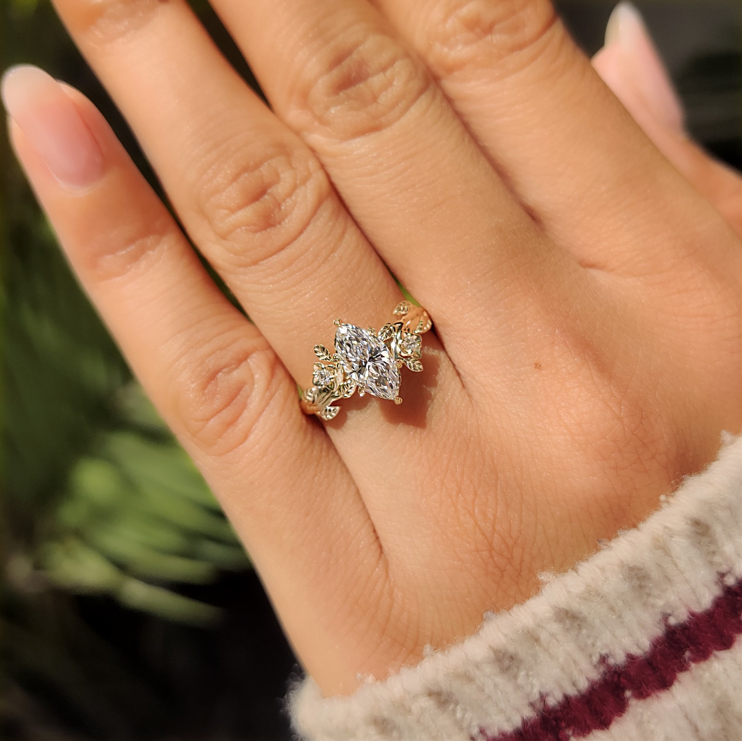 Handmade marquise diamond ring with floral and leaf accents
