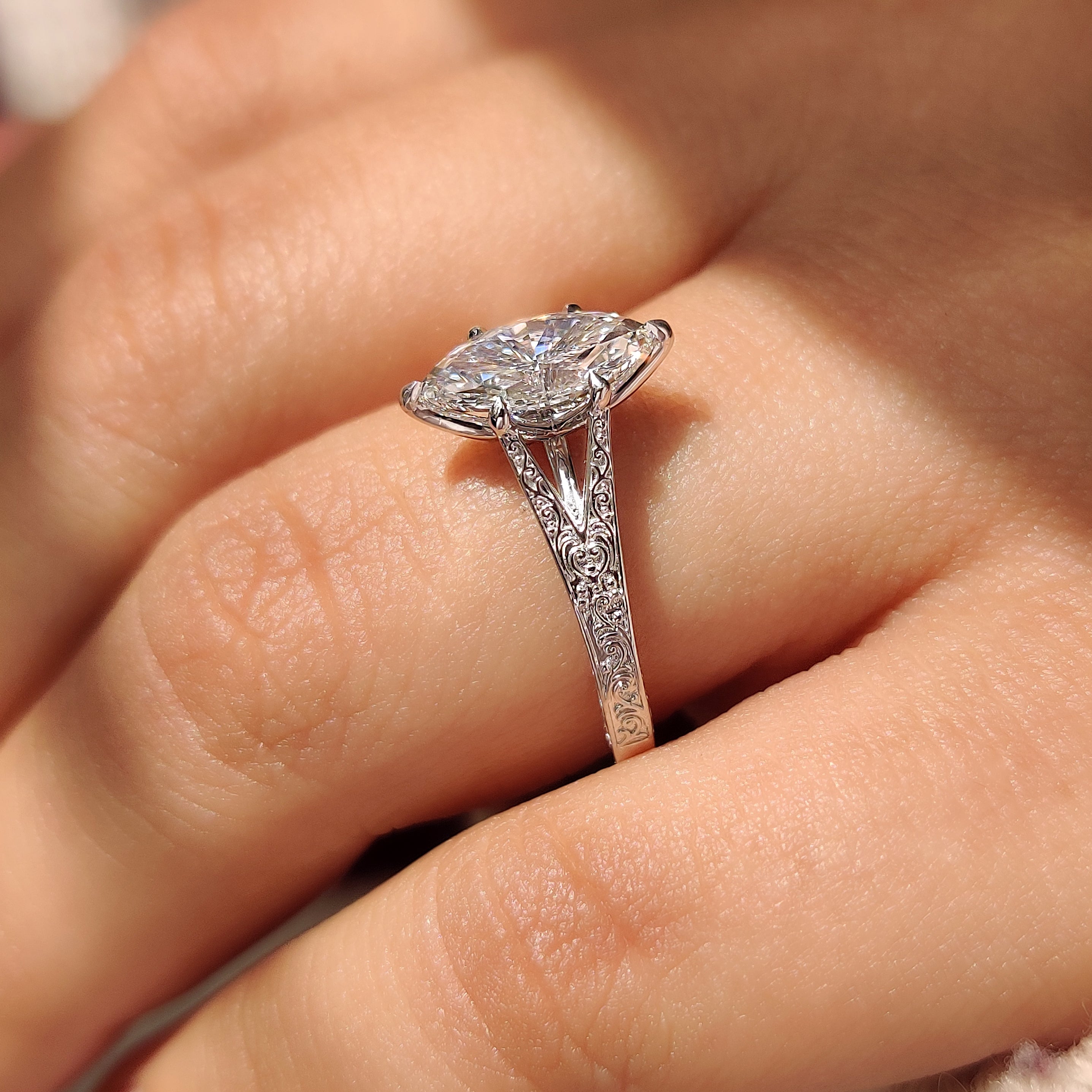 Split shank marquise diamond ring with six claw prongs.
