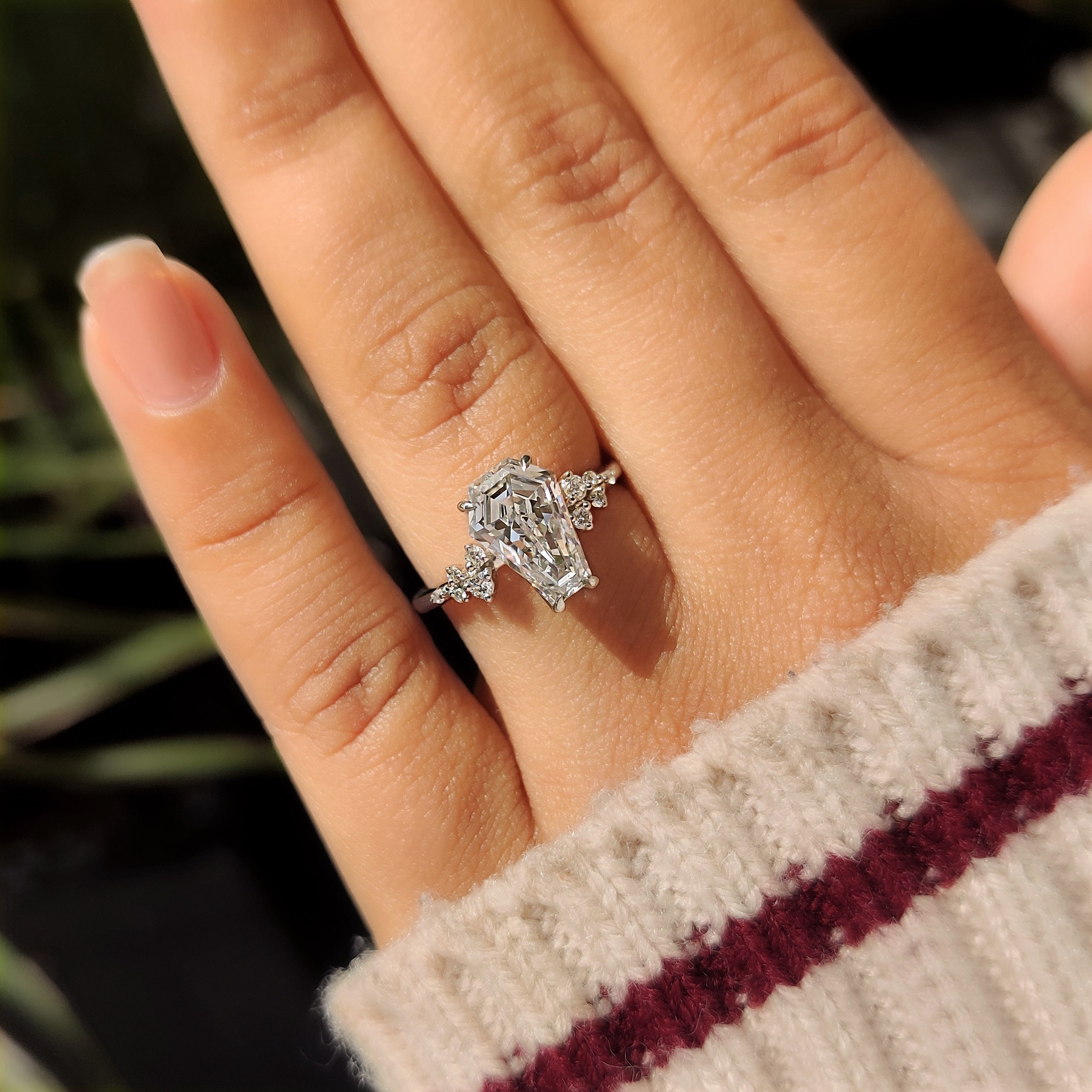 Round side stone coffin diamond ring with hidden details
