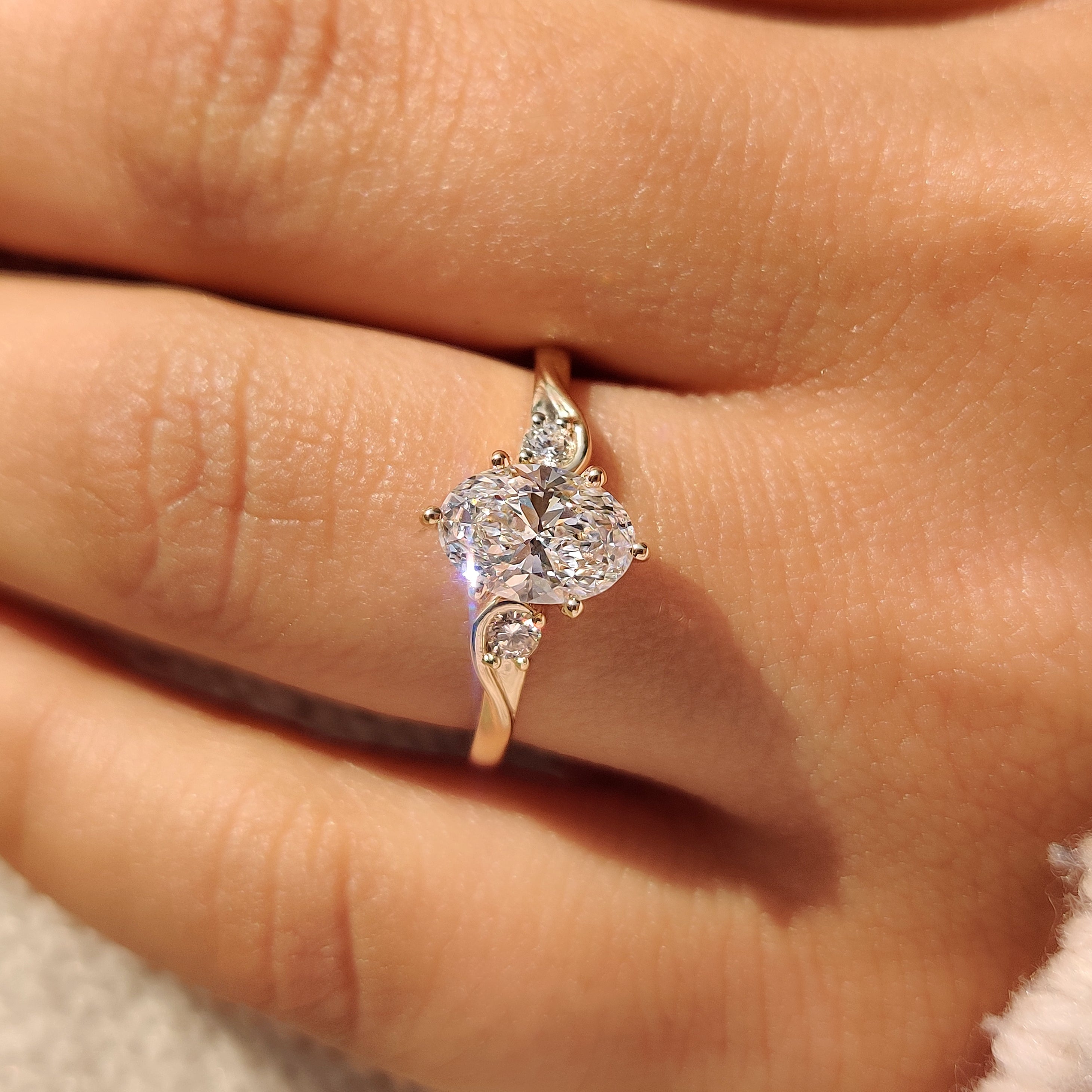 Oval engagement ring with three stone and basket setting
