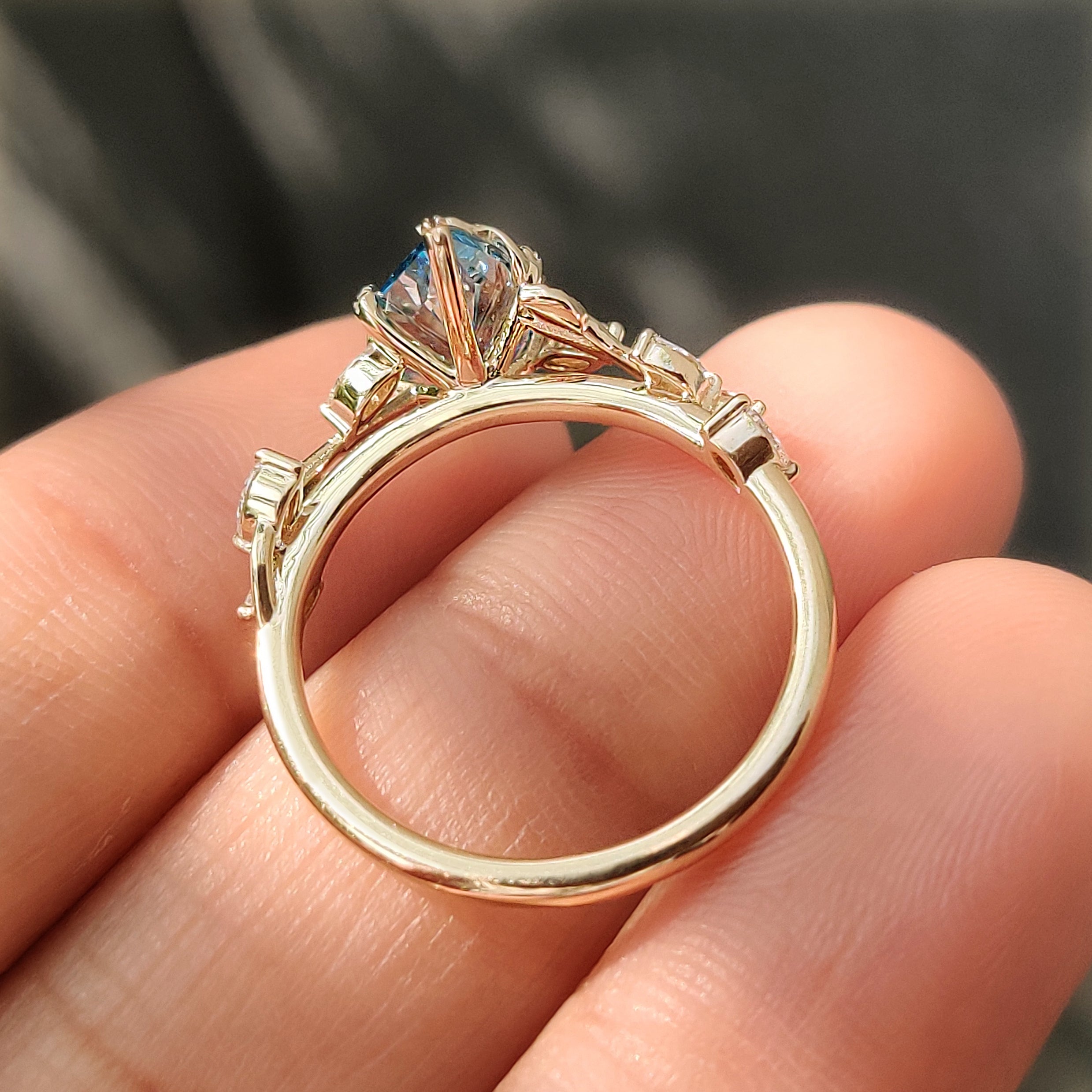 Leaf style prongs holding the blue Dutch marquise diamond.
