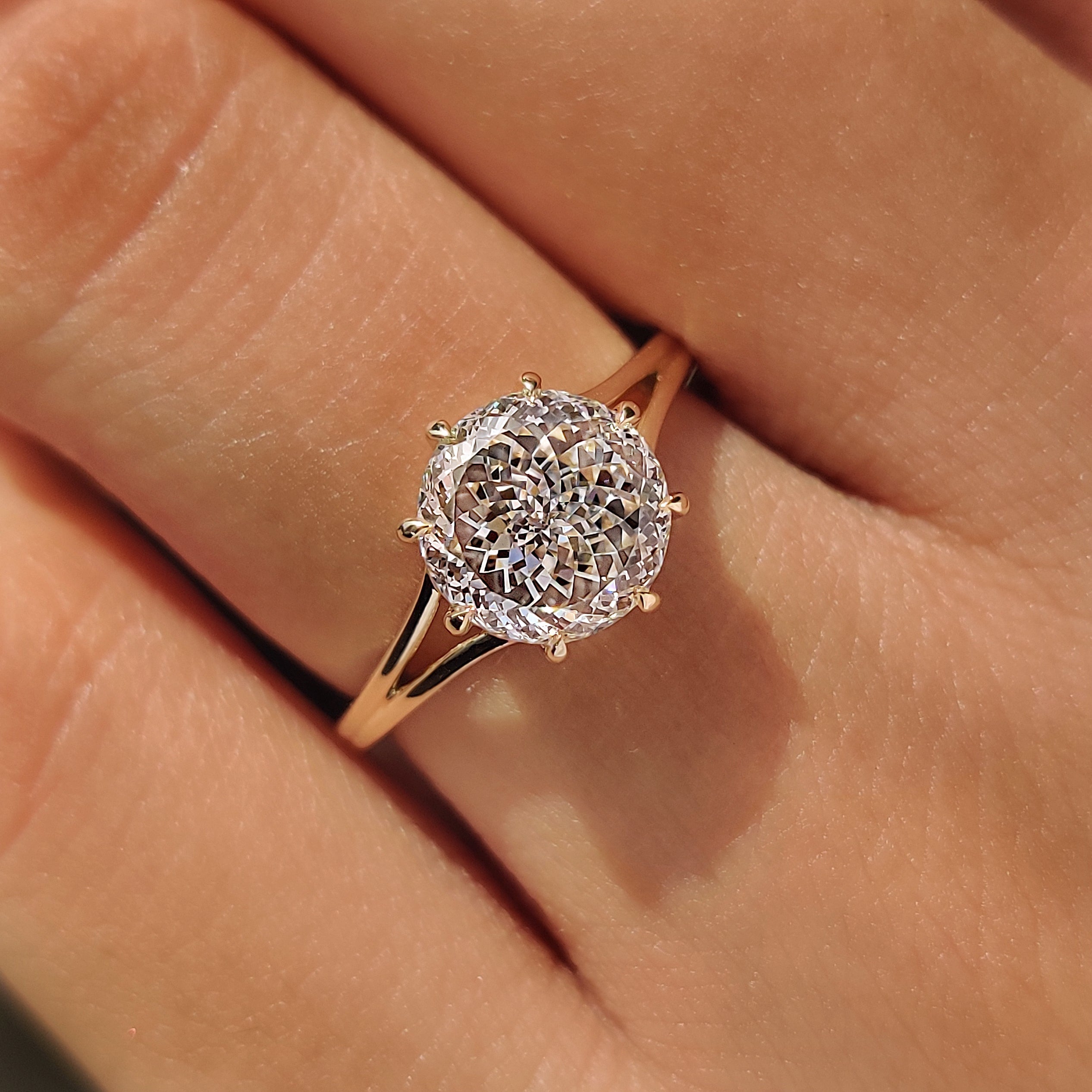 Portuguese cut center diamond with split shank ring design.

