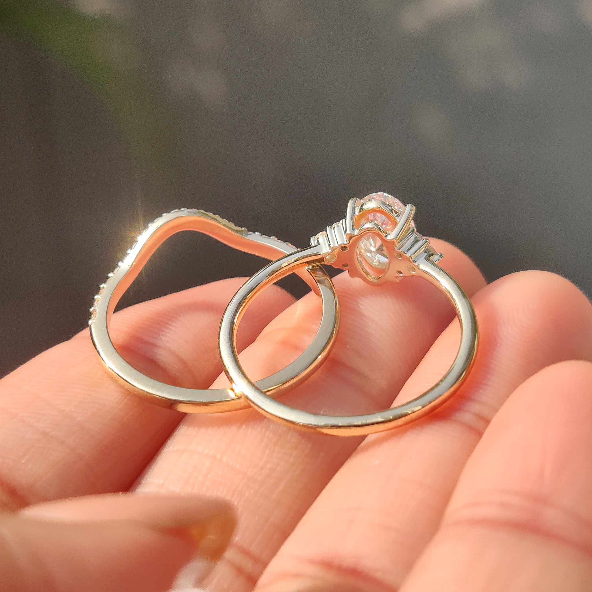 Curvy oval engagement ring with u shaped diamond band.
