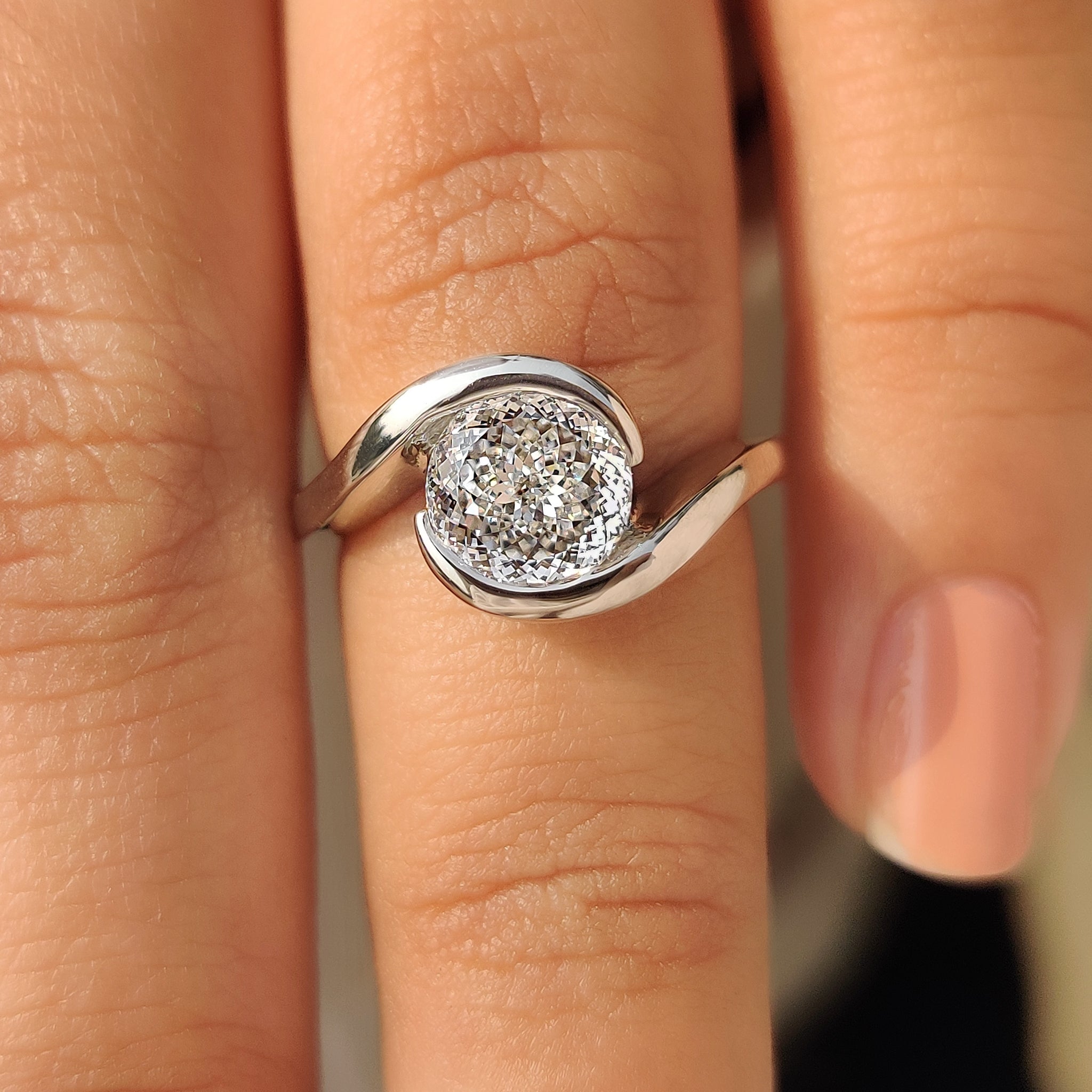 Portuguese cut lab diamond ring with smooth bypass design.
