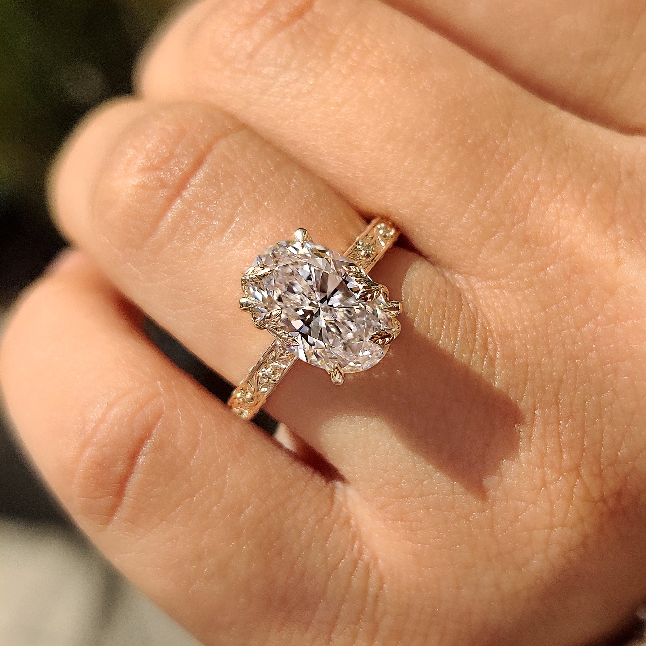 Oval diamond engagement ring with four claw prong setting
