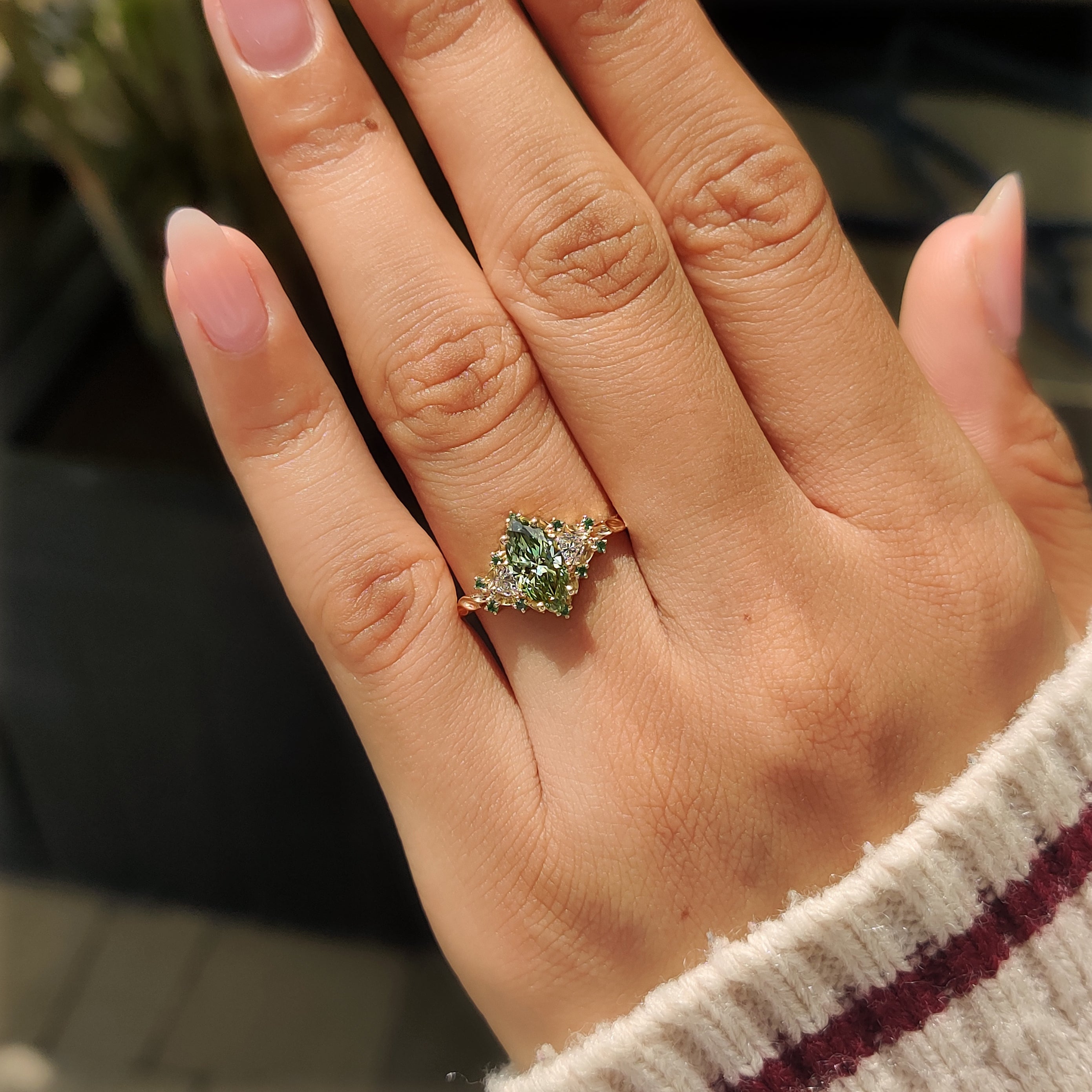 Green marquise ring with rounded prong setting.
