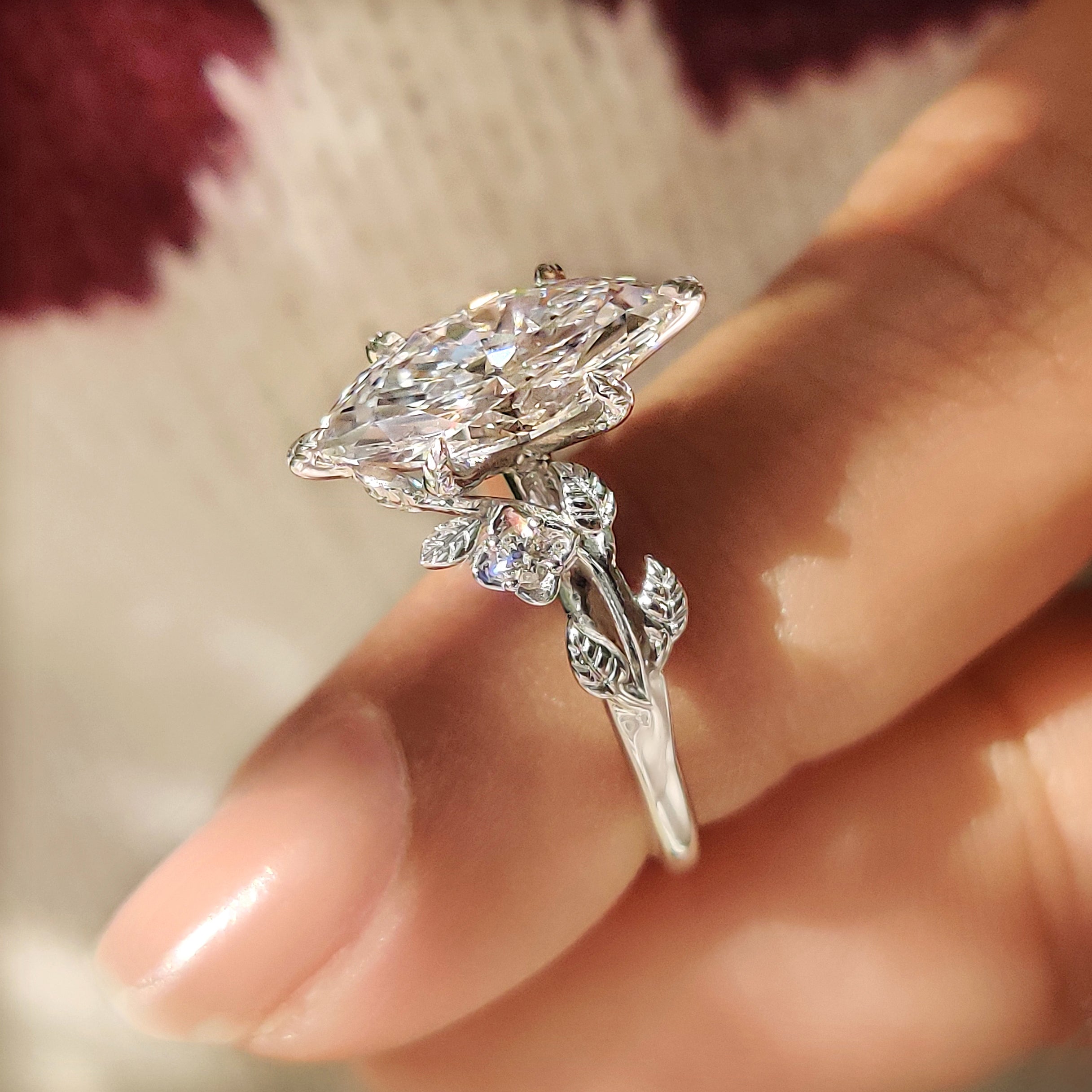 Handmade marquise engagement ring with six leaf prong setting.
