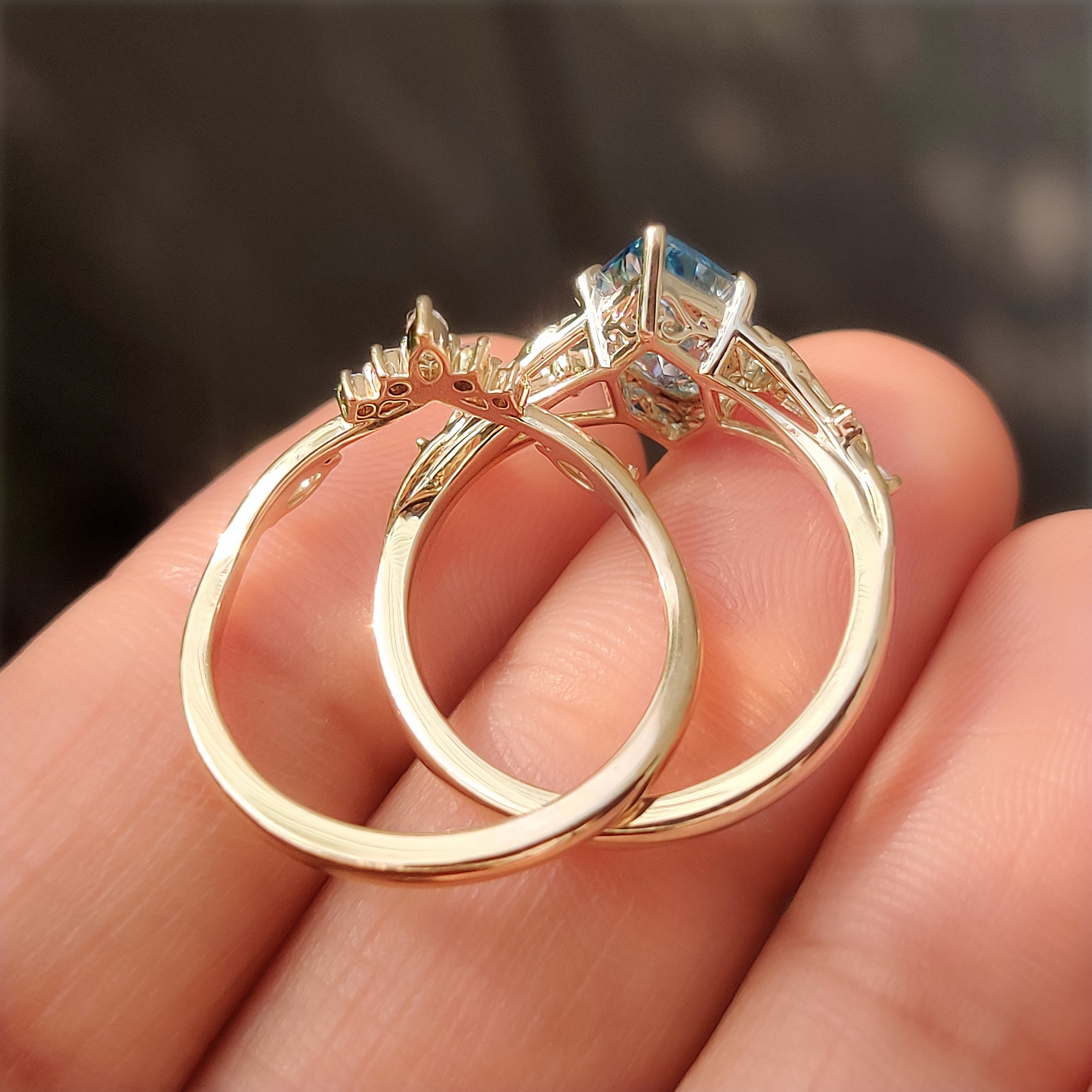 Six claw prong setting on a blue Dutch marquise center diamond.
