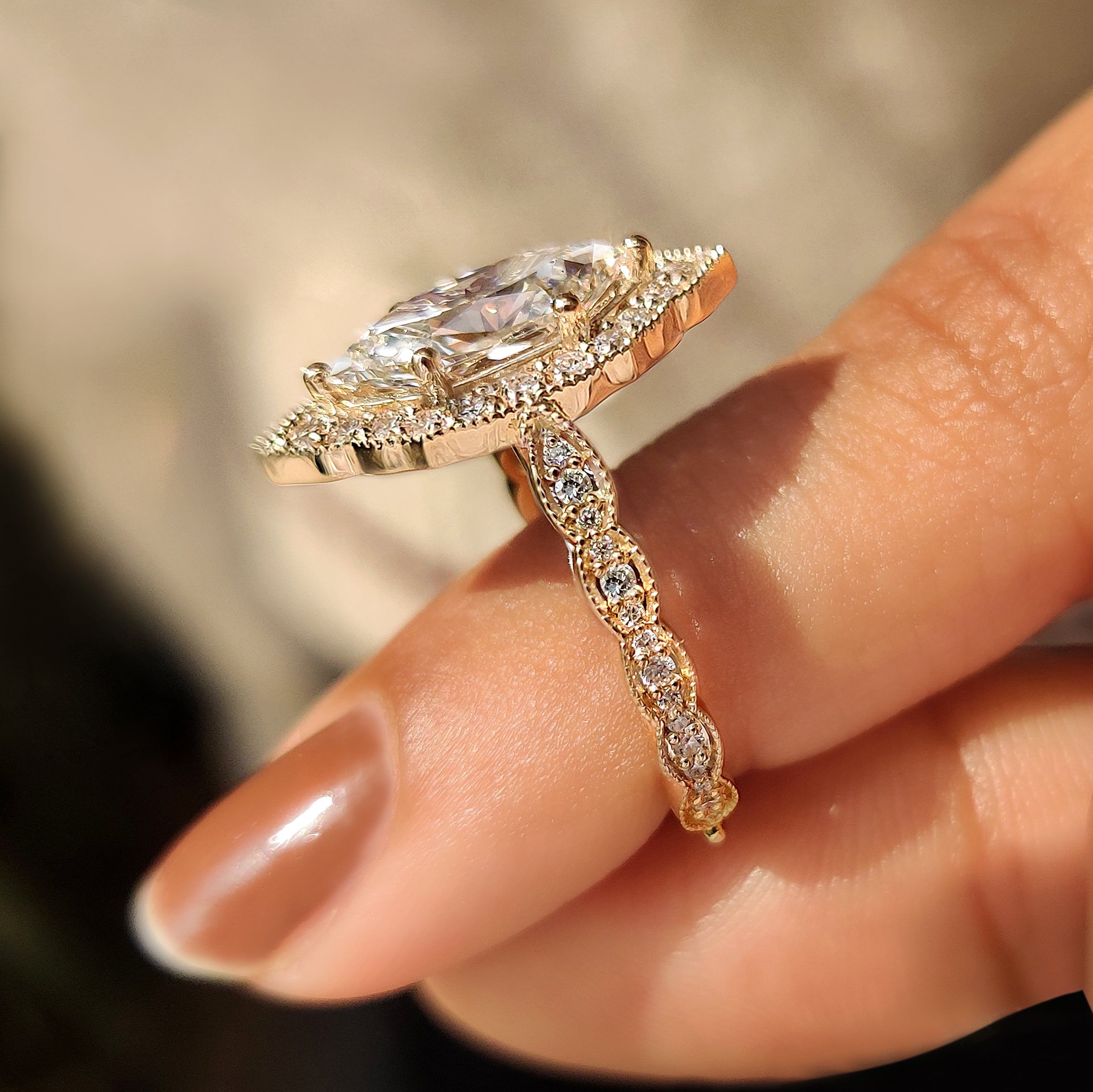 Dutch marquise engagement ring with milgrain and side stones.
