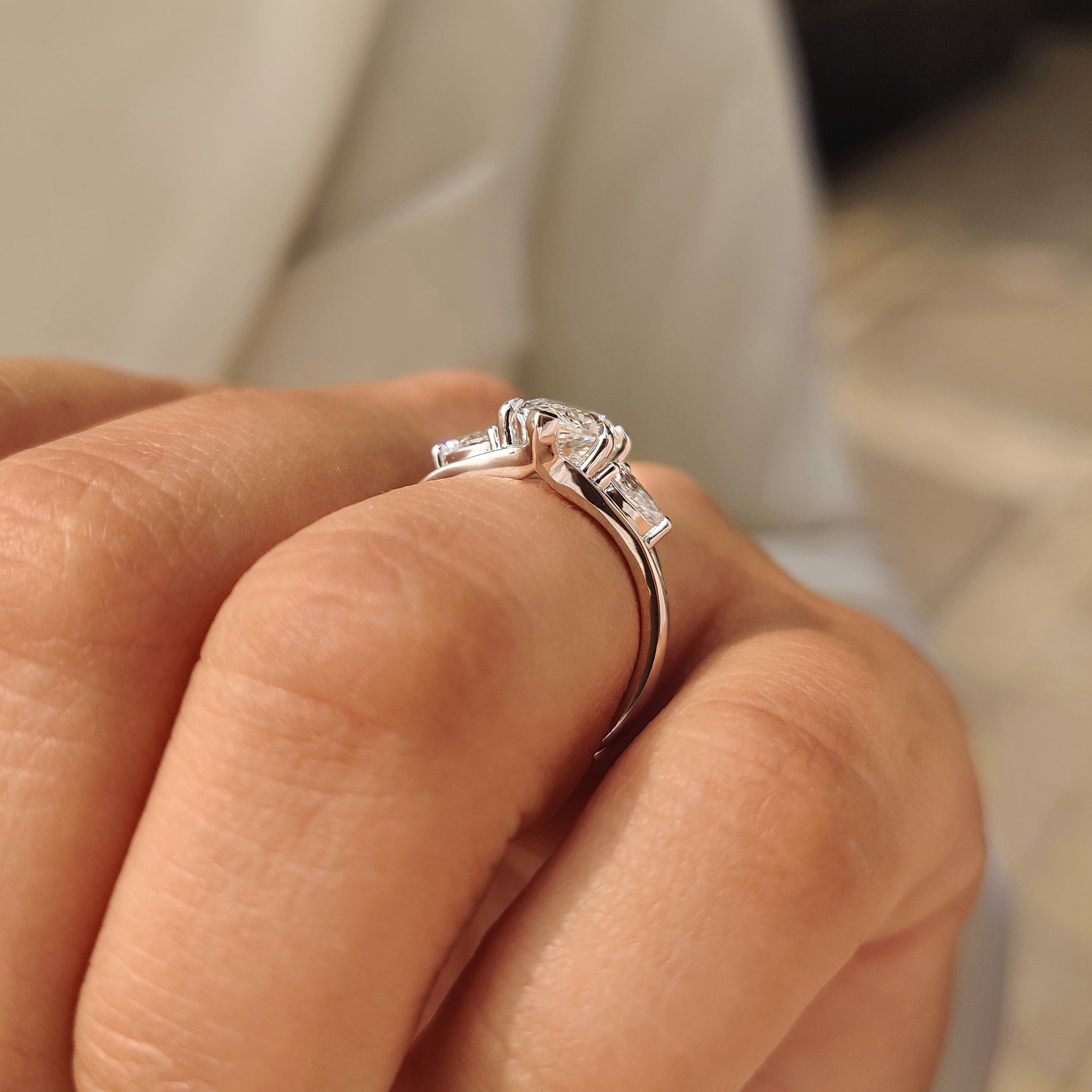 Lab grown marquise ring with pear side stone accents.
