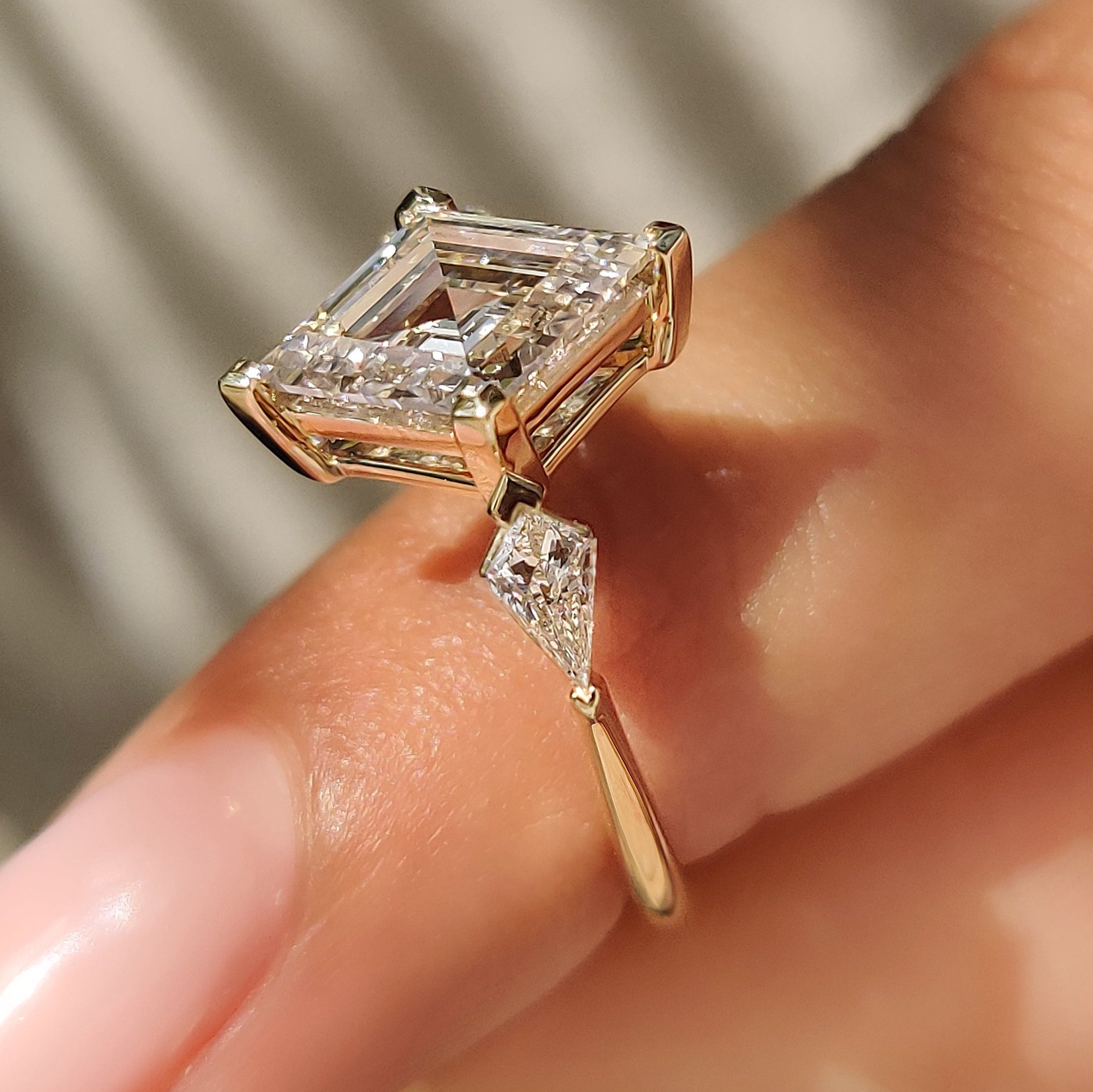 Handmade three stone diamond ring with kite side accents
