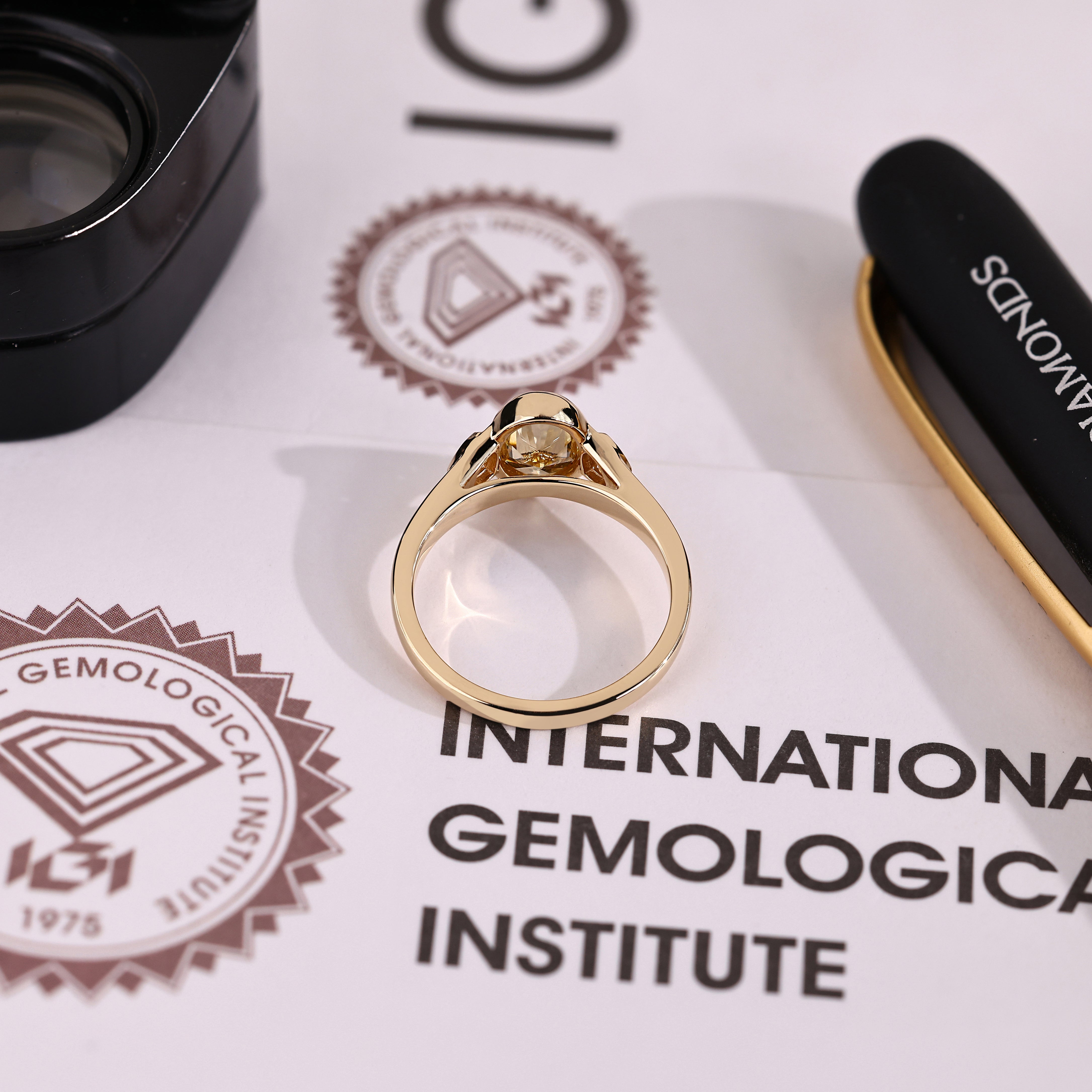 IGI certified oval ring with light yellow center stone
