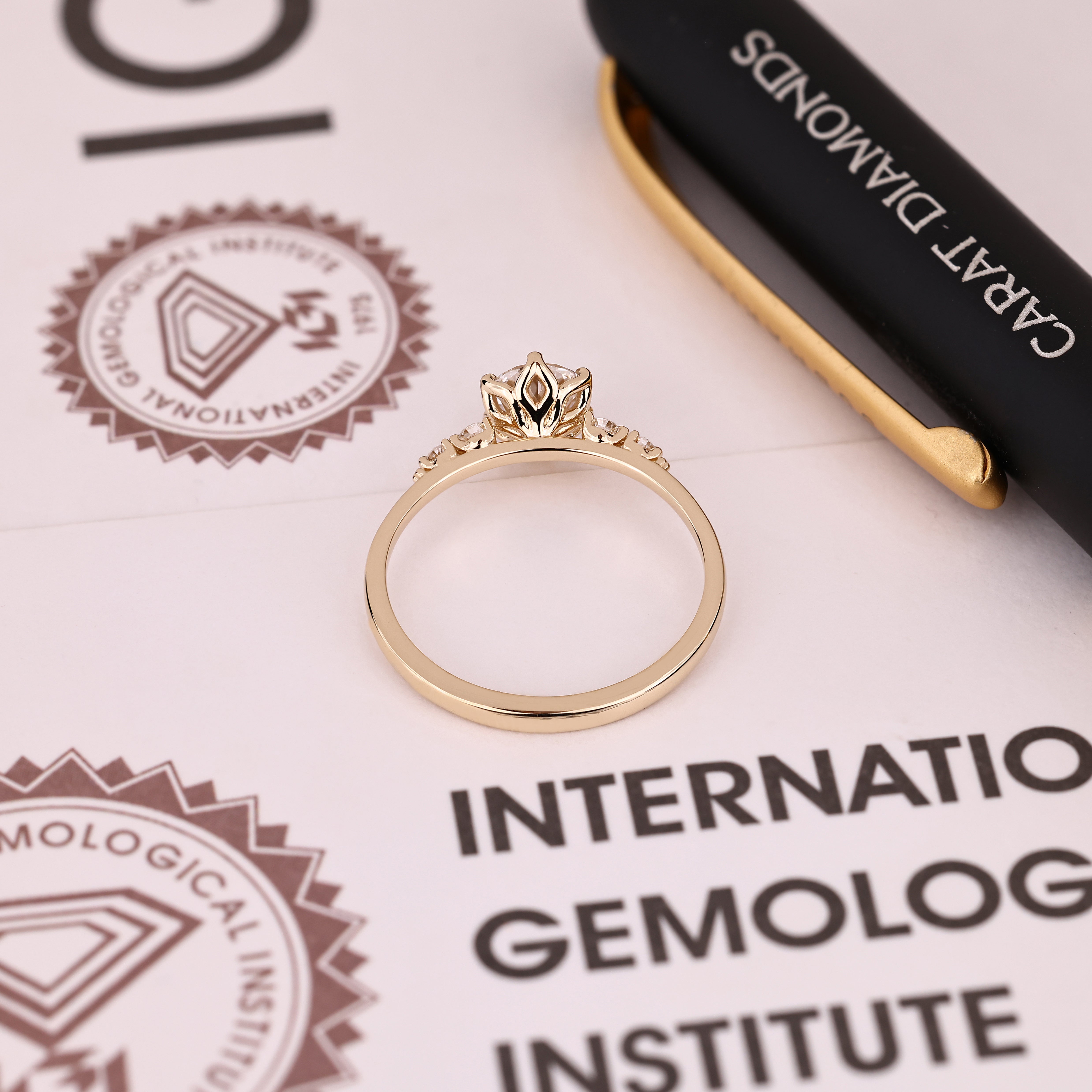 IGI certified round diamond ring with side stone accents
