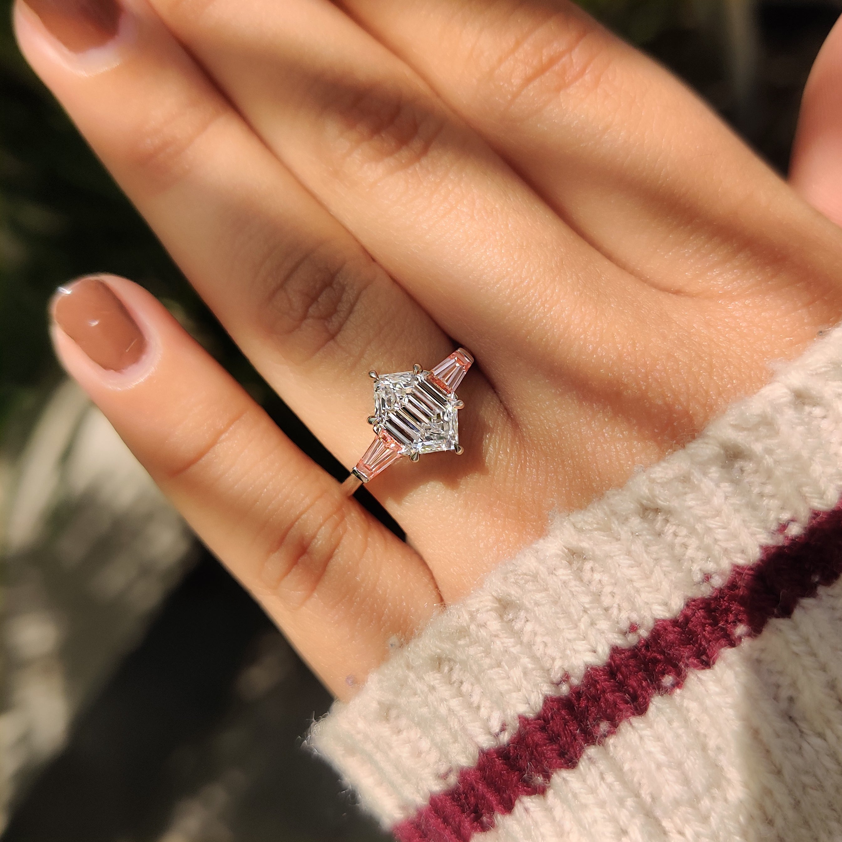 Three stone ring with cathedral setting and claw prongs
