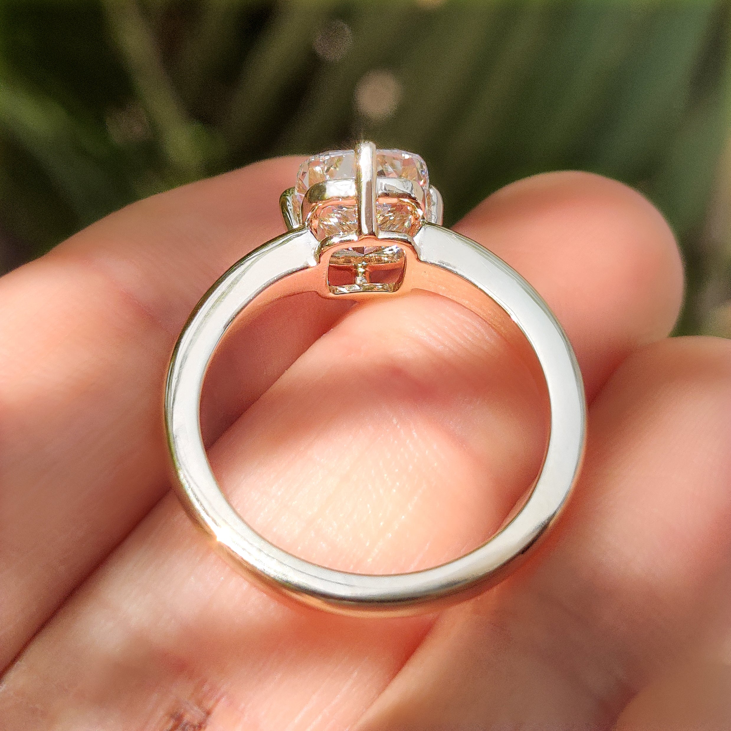 Handmade cushion diamond ring with four compass prongs
