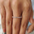 Custom wedding band in rose gold with moissanite stones, handcrafted for lasting beauty.