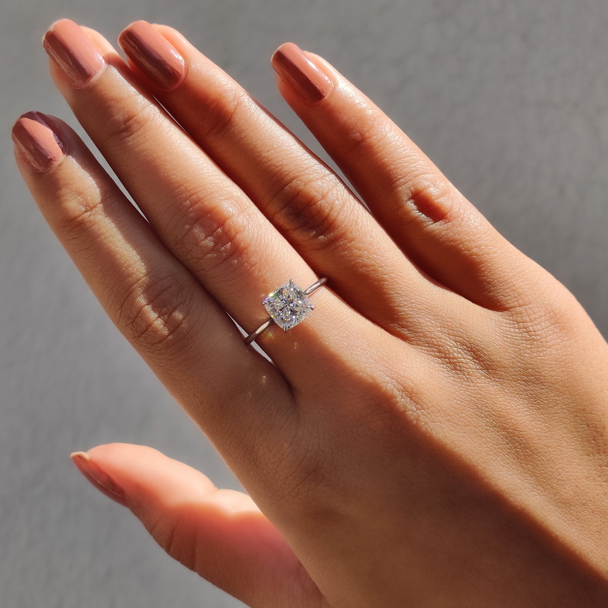 A cushion cut solitaire ring offers a classic and refined design.
