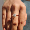This solitaire engagement ring highlights the center stone with elegance.
