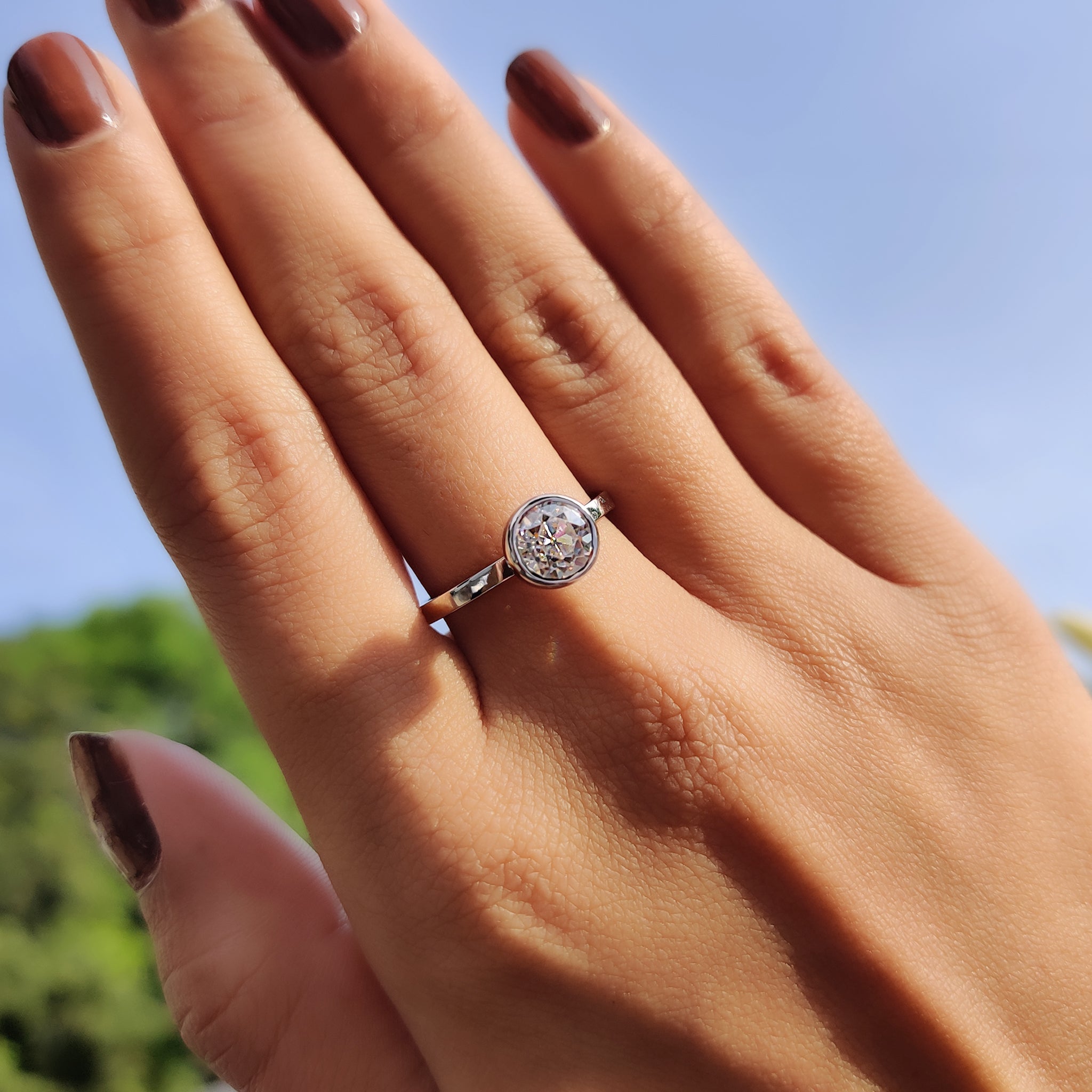 Simple white gold ring with round cut moissanite.