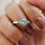Bezel moissanite solitaire ring in white gold.