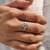 Round cut solitaire moissanite engagement ring.