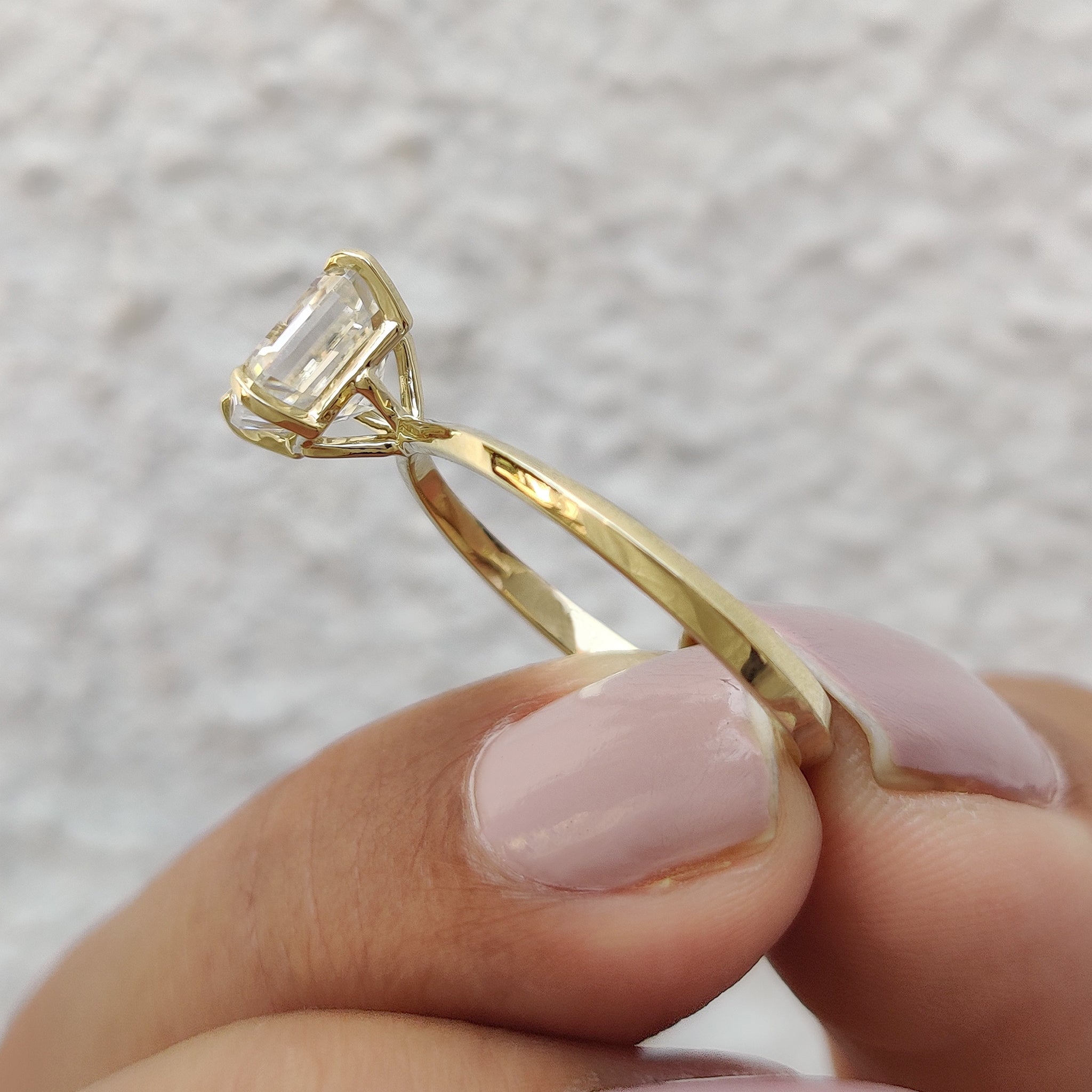 Elegant 4 Tab Prong Settings enhancing the beauty of a solitaire gemstone.