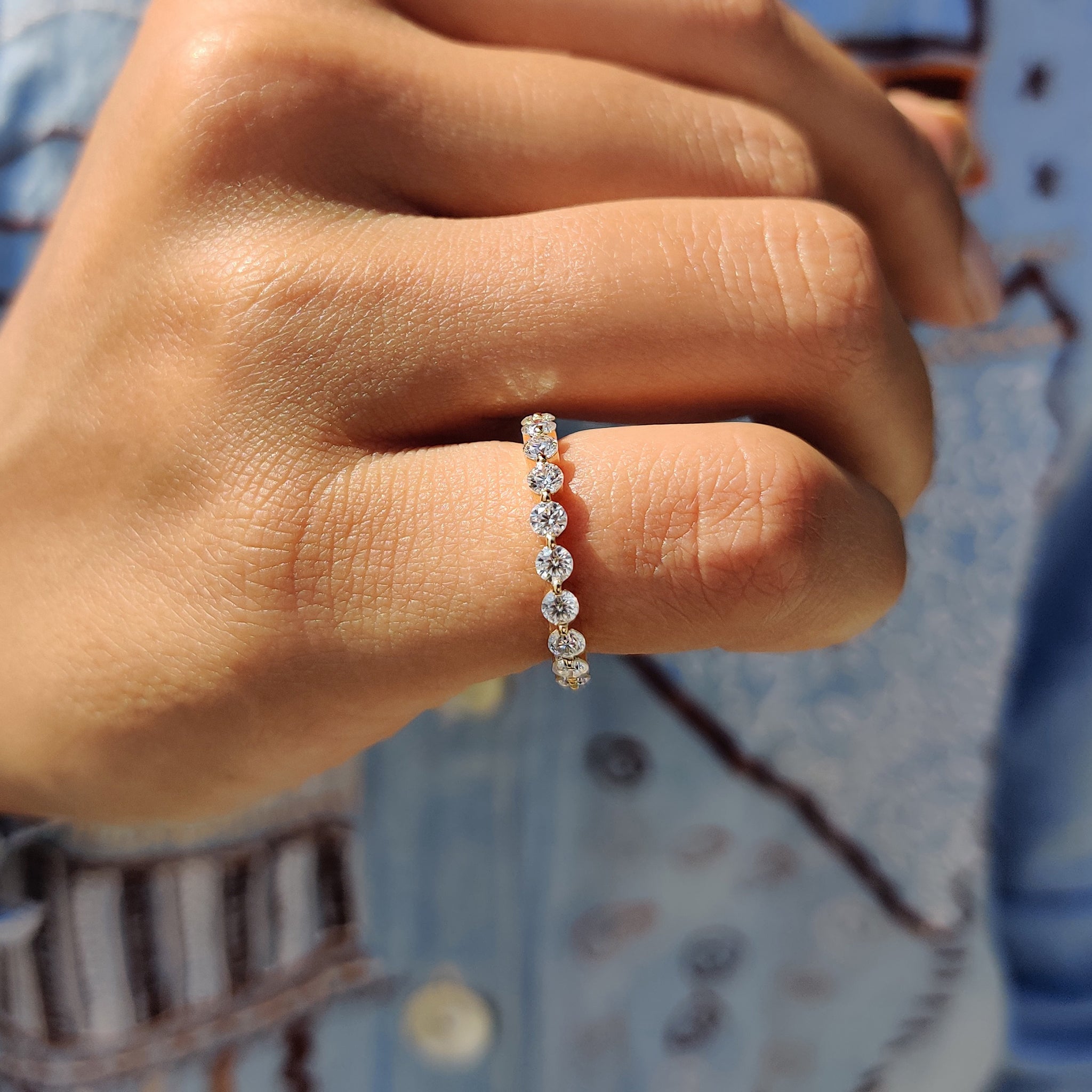 Yellow gold band with a unique floating design and round cut moissanite.