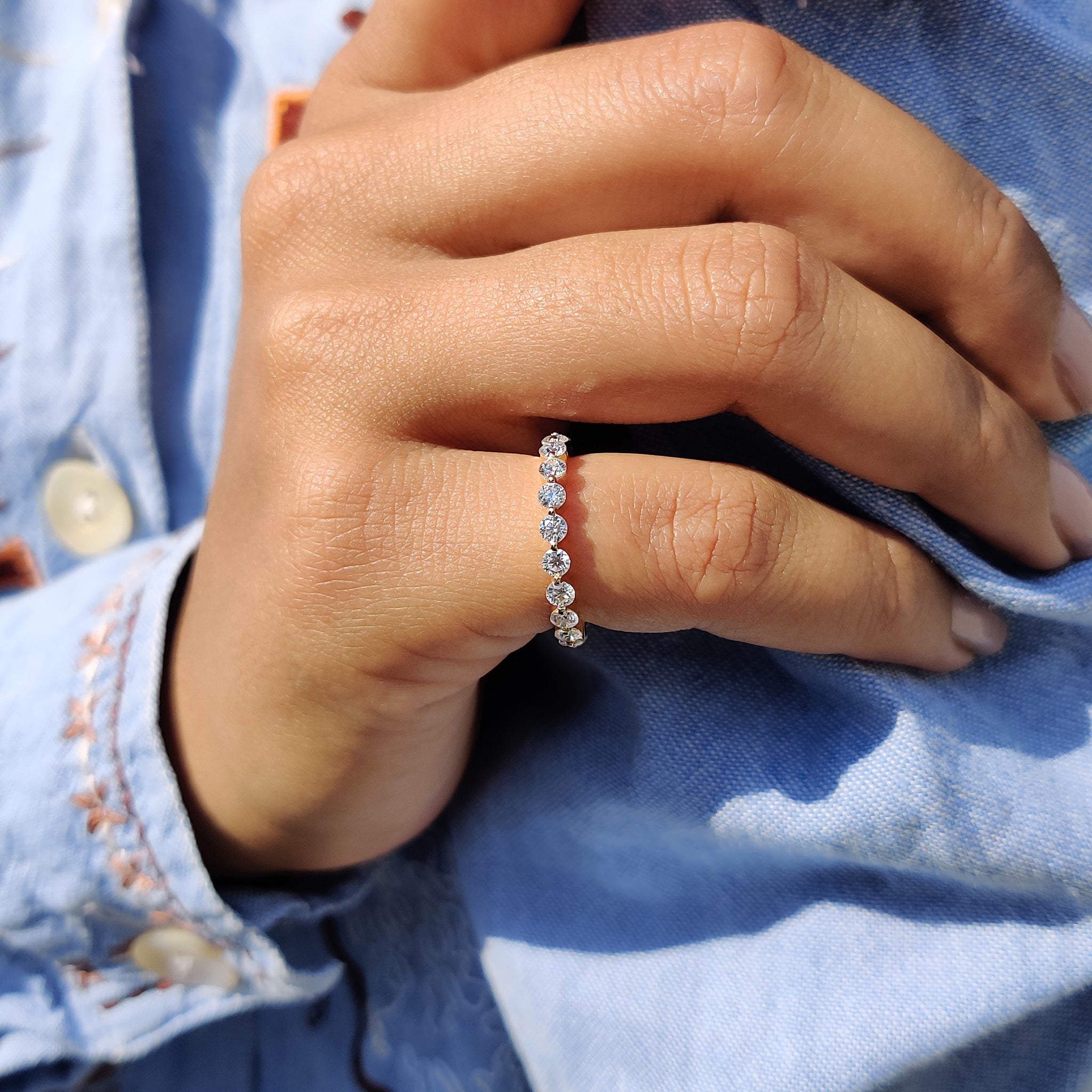 Handmade band with round cut moissanite and a unique floating design.