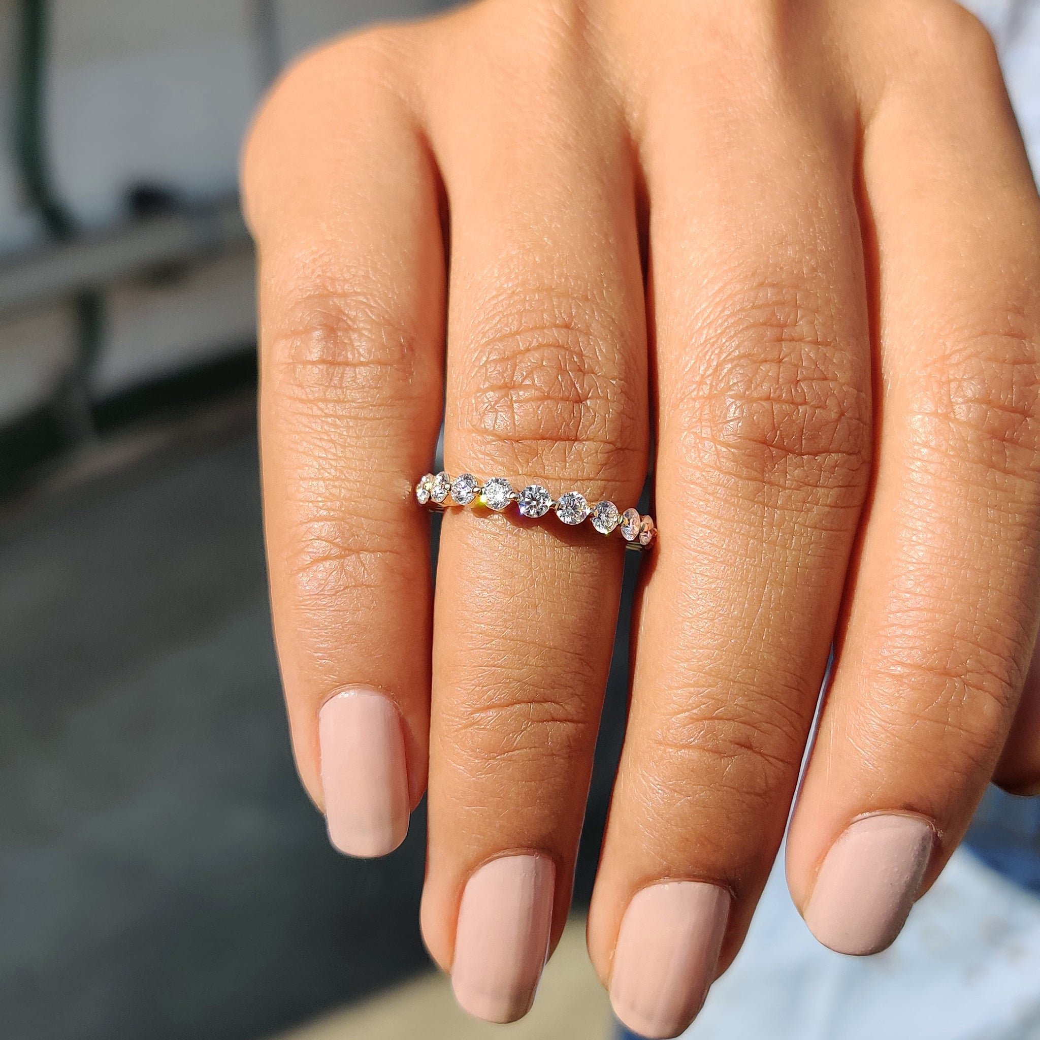 Bubble prong wedding band in yellow gold with round cut stones.