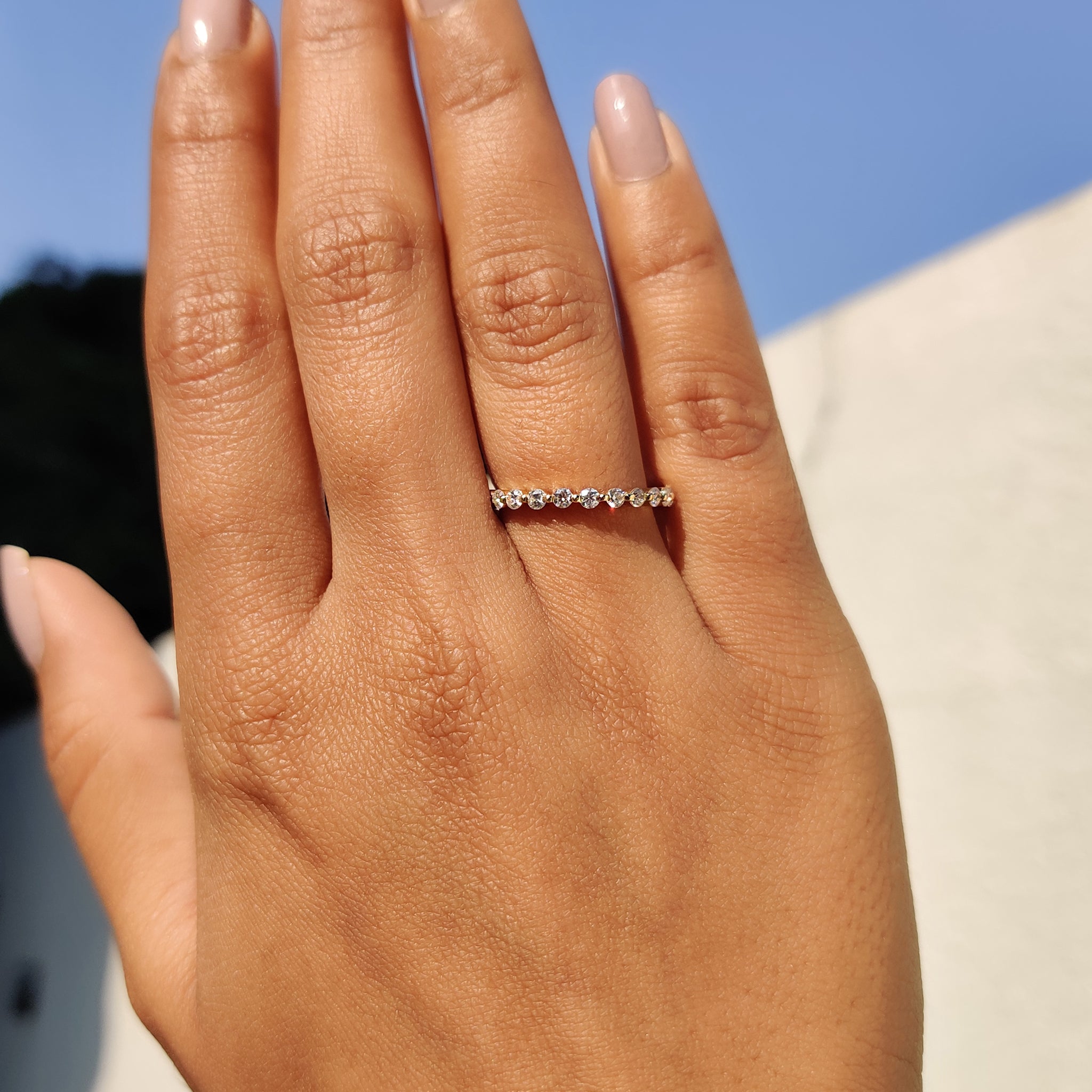 Eternity Wedding Band with sparkling Moissanite stones in yellow gold.