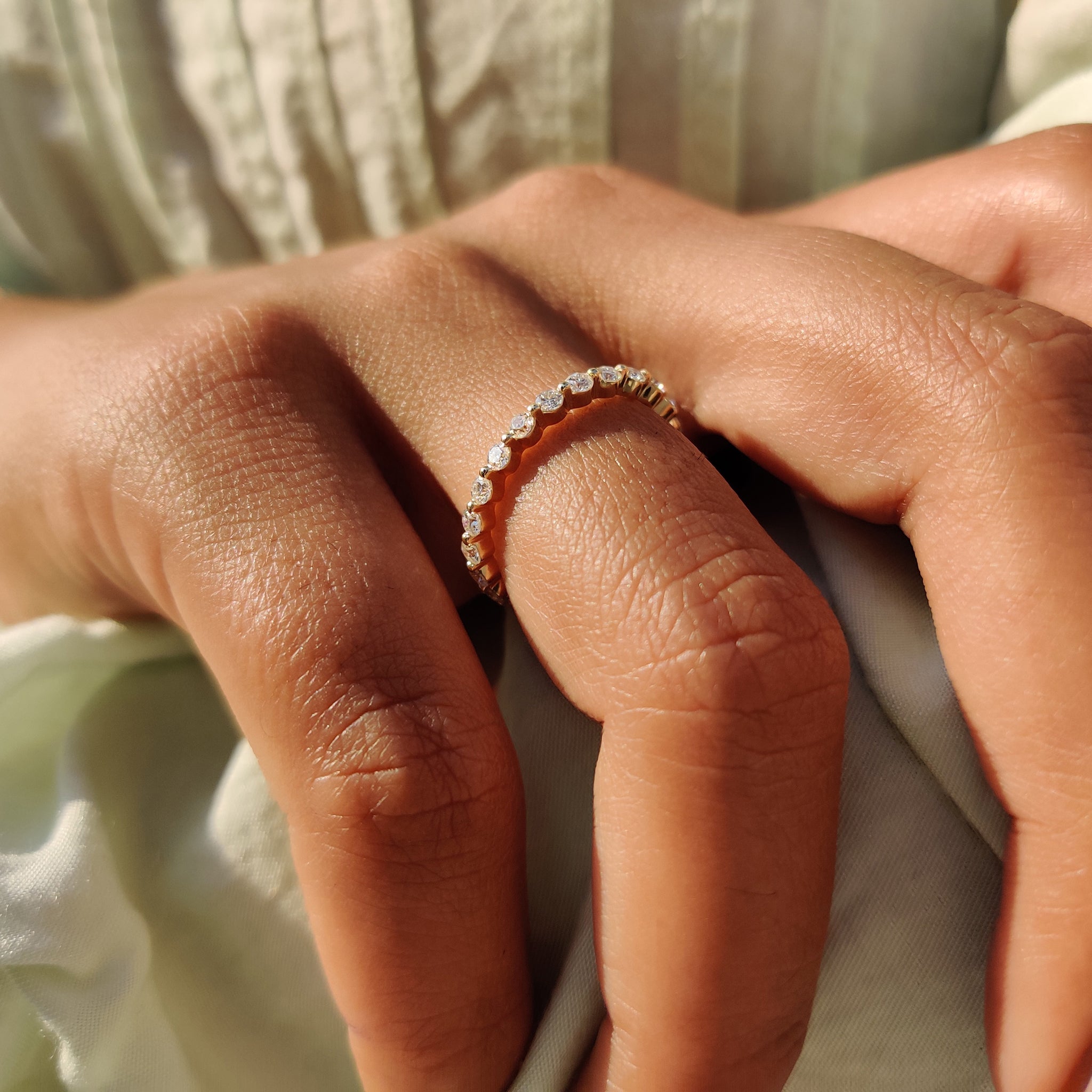 Floating bubble wedding band design with brilliant round Moissanite.