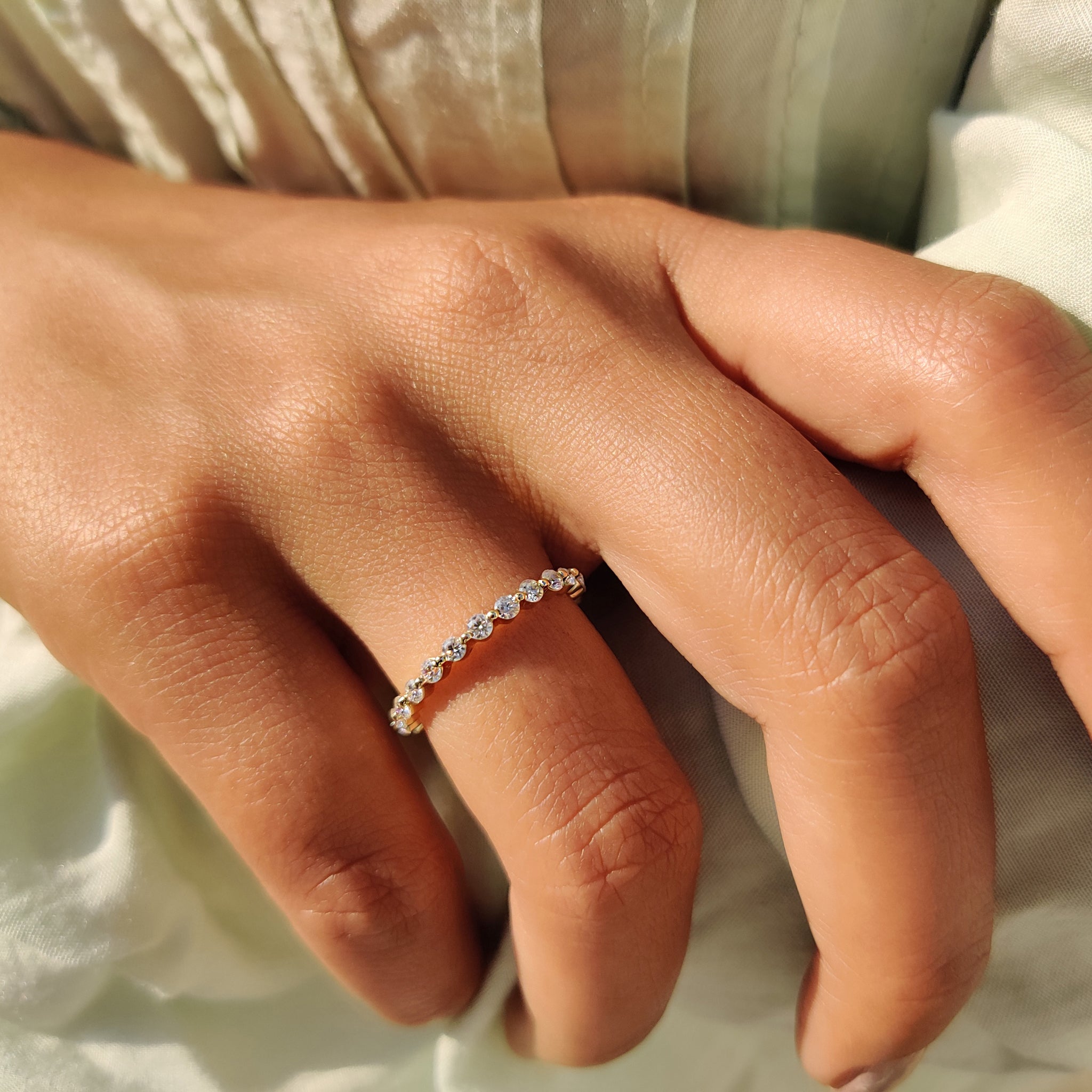Prong set band with round Moissanite stones for a classic wedding look.