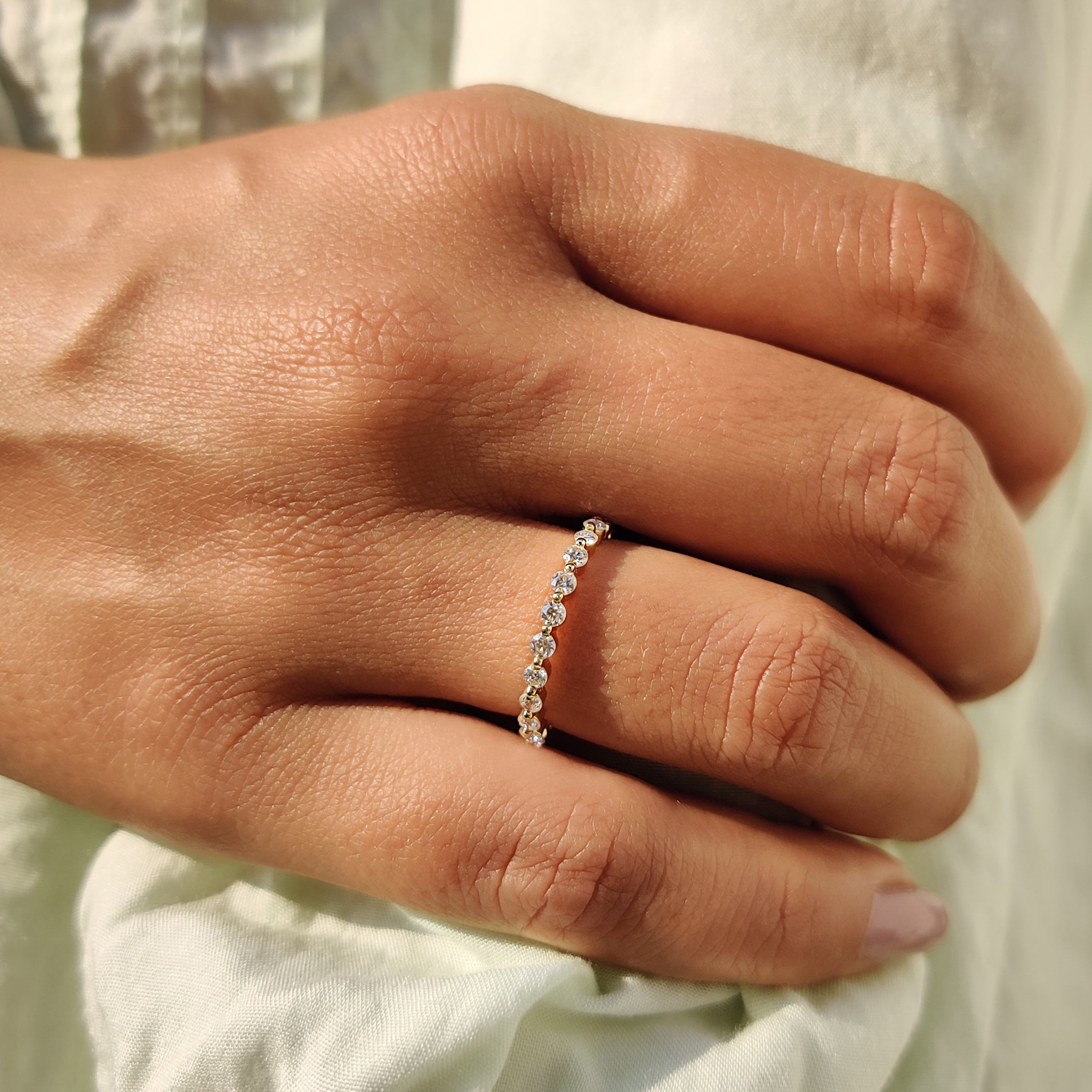 Round Moissanite wedding band set in yellow gold for a unique style.