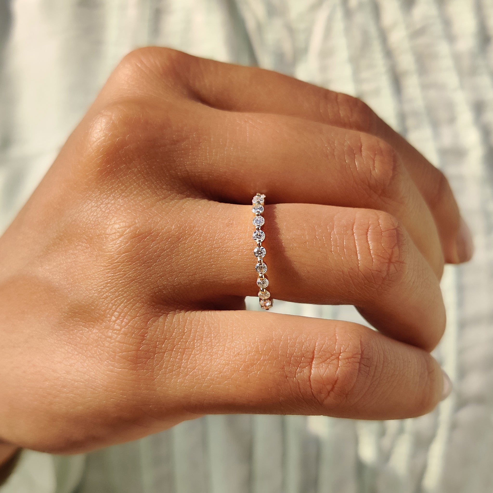 Yellow gold band featuring brilliant Moissanite stones for added sparkle.