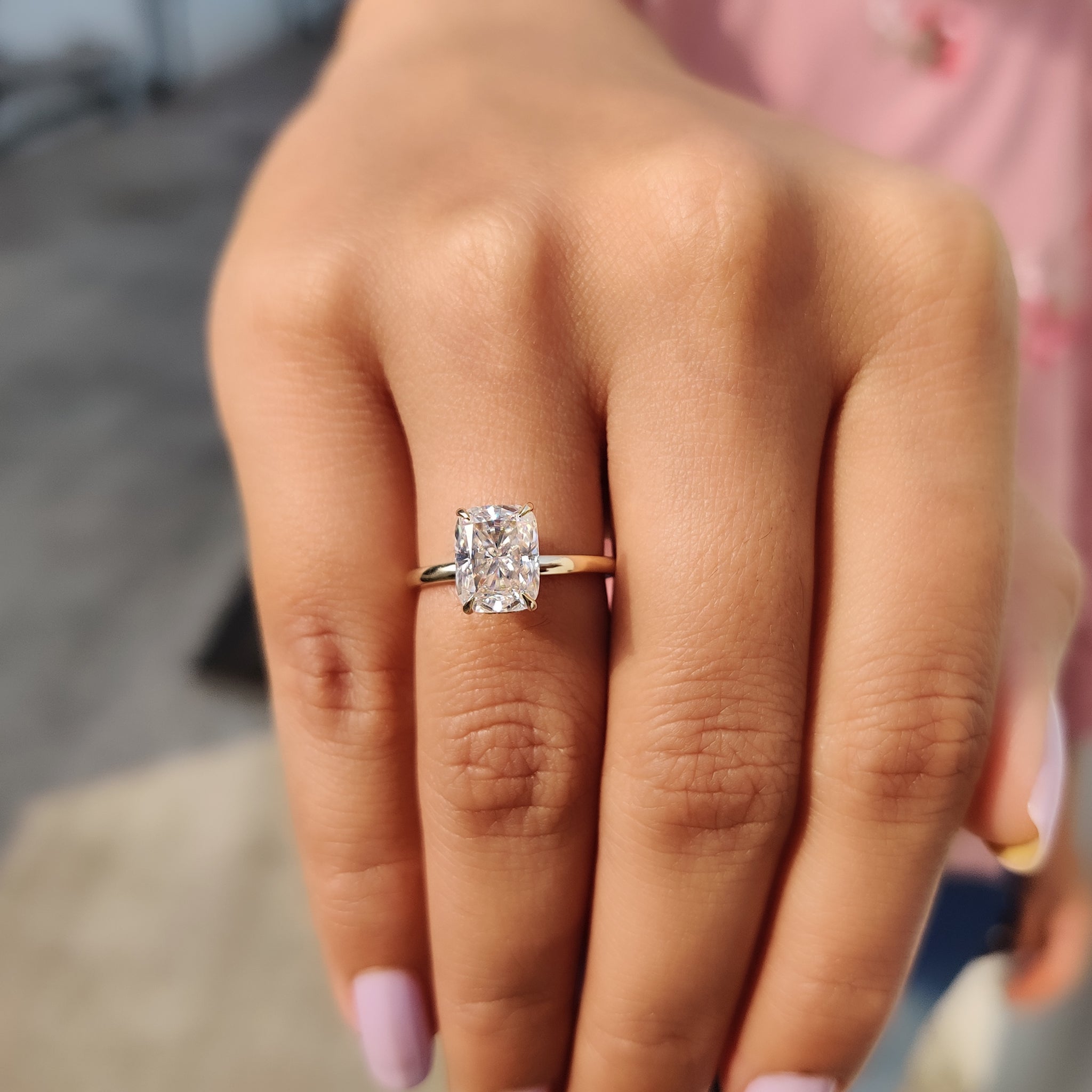 Cushion with round hidden halo ring in four prongs.