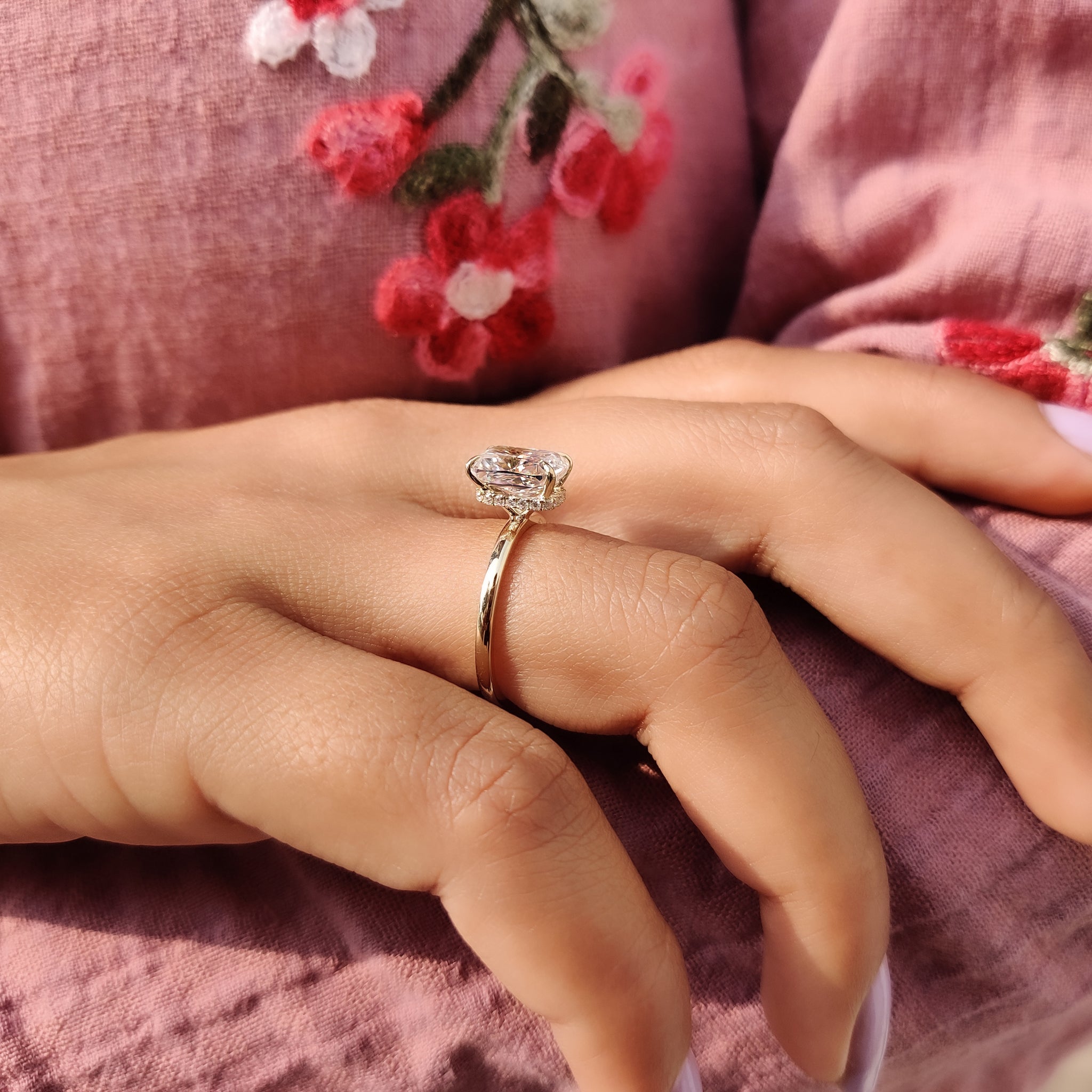 Cushion cut hidden halo engagement ring in gold.