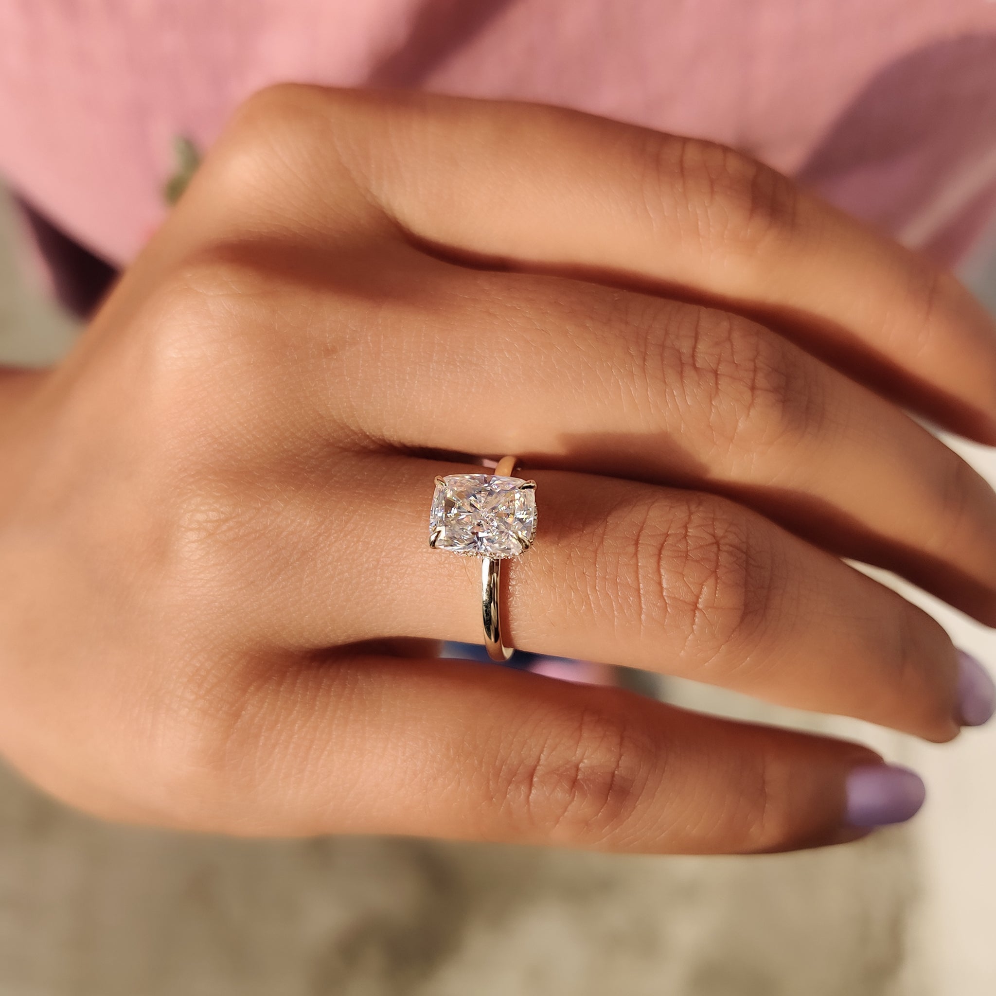 Hidden halo cushion cut ring with handmade gold band.