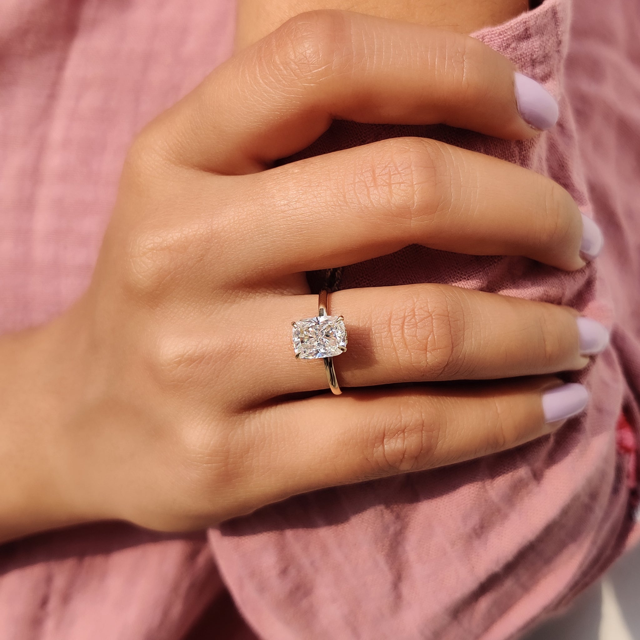 Carat Diamonds ring with cushion cut and halo design.
