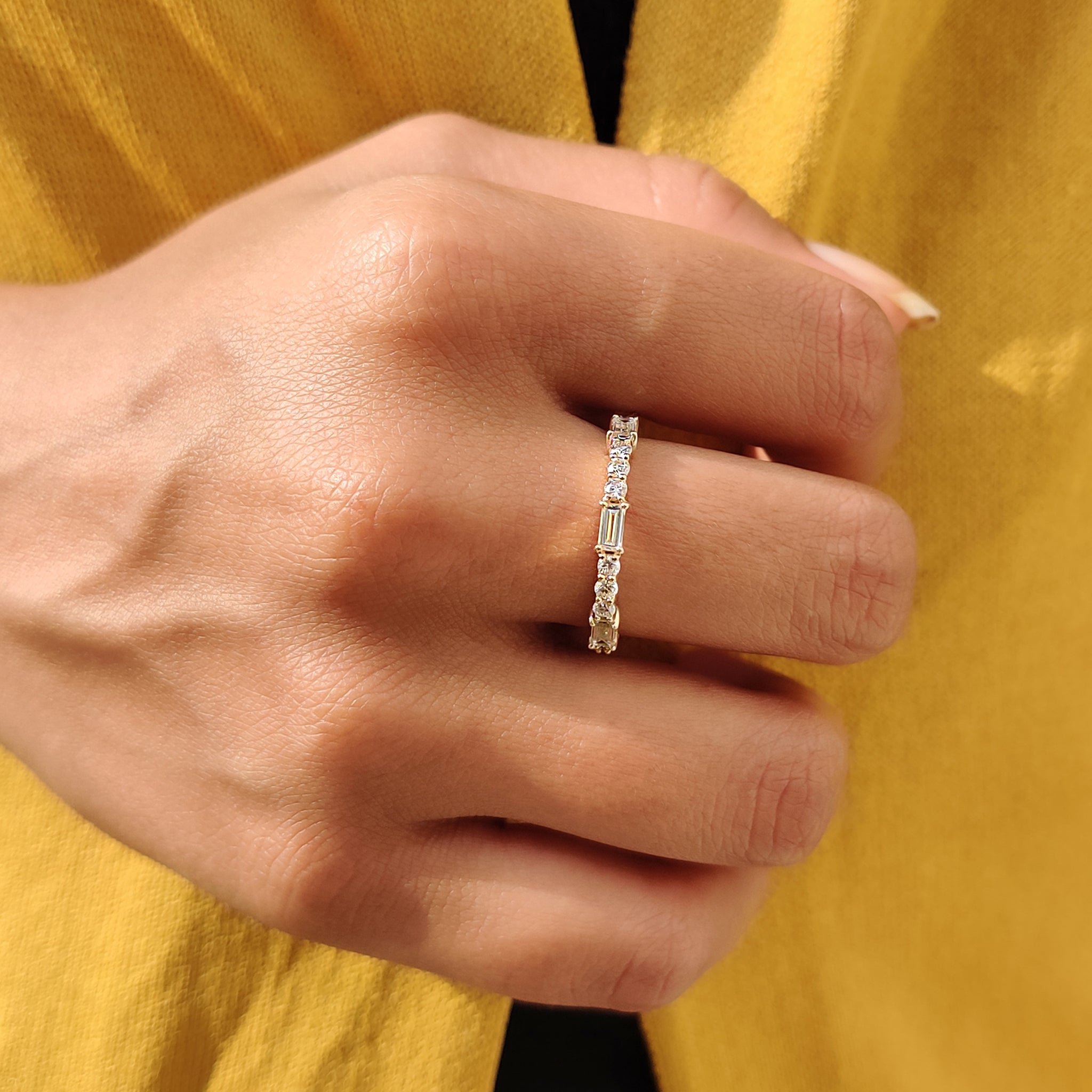 Custom moissanite band featuring a prong set wedding band.