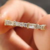 Handmade jewelry with a round and baguette moissanite eternity band.