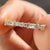 Handmade jewelry with a round and baguette moissanite eternity band.